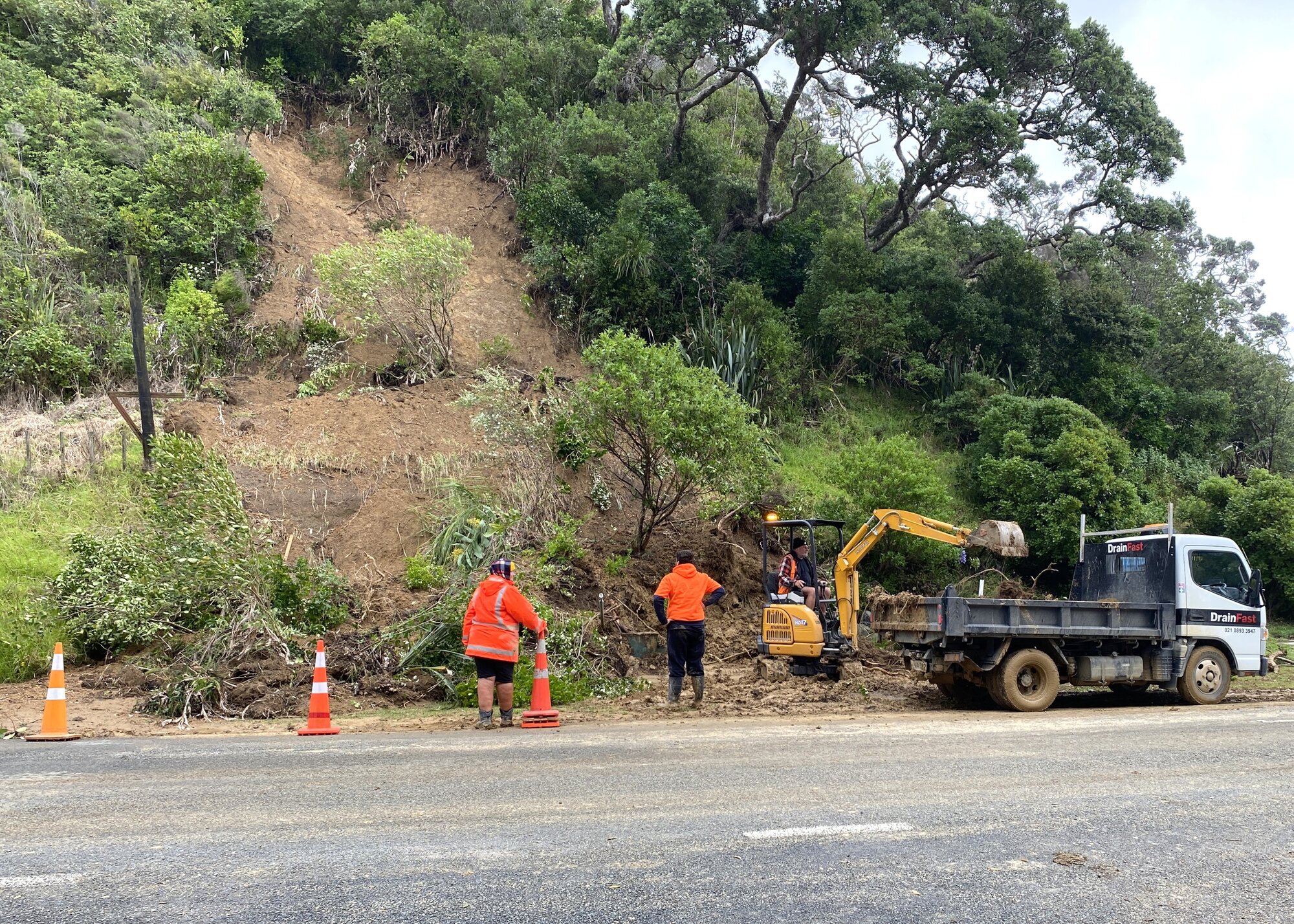 Contractors clear a slip from a wastewater pumping station at Ōakura. Whangārei mayor Ken Couper says unfortunately, sewage has spilled into the sea and people should avoid the stormwater and not eat any shellfish. Photo / Denise Piper