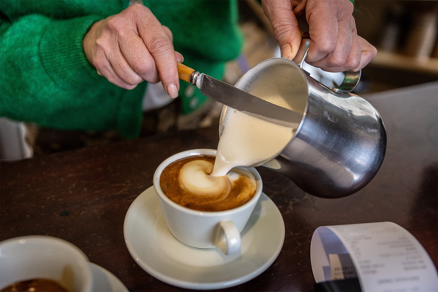 Victoria takes the fluff out of a flat white. Photo / Michael Craig