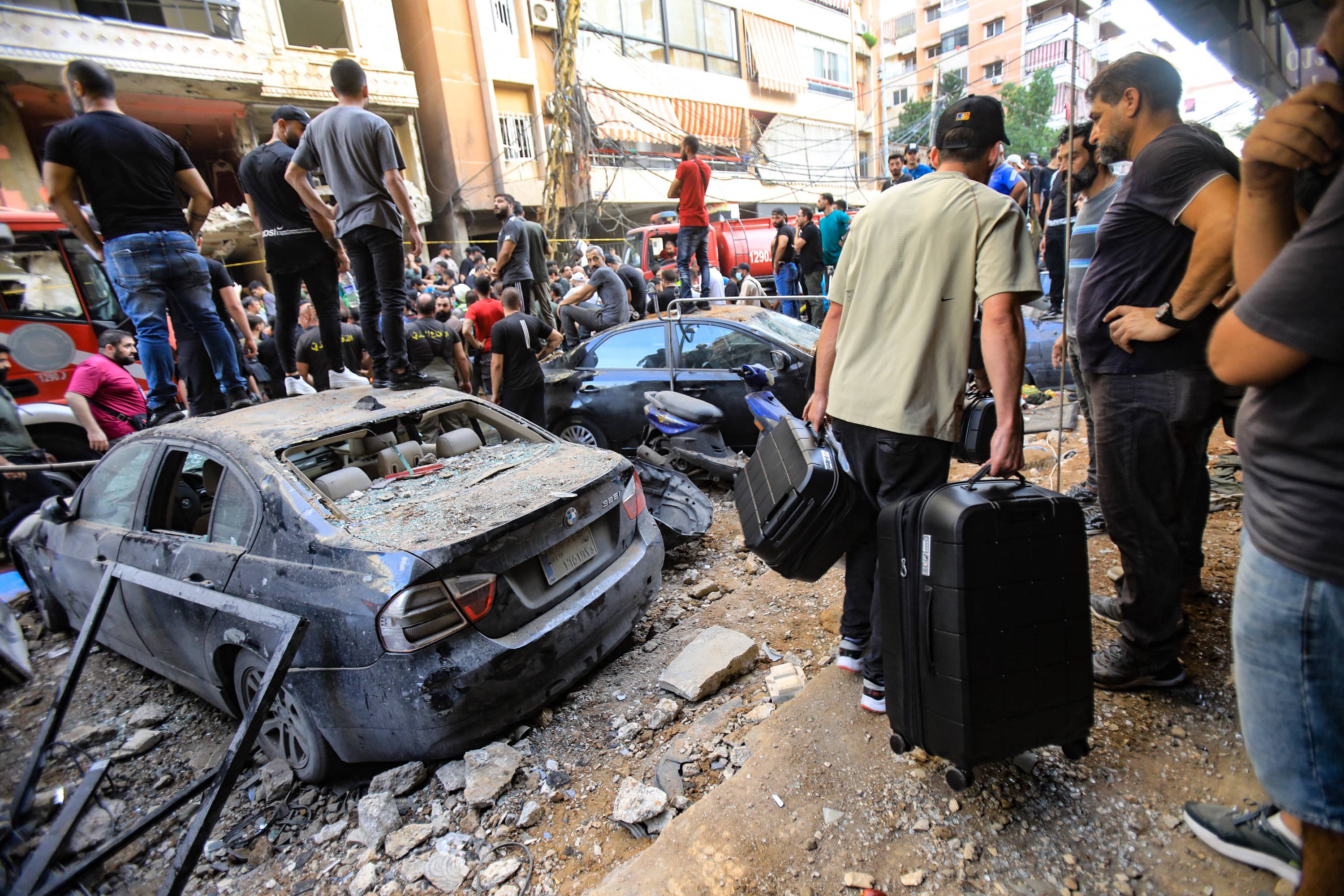 People gather in front of a building targeted by an Israeli strike in Beirut's southern suburbs. The strike on Hezbollah's stronghold in Lebanon's capital Beirut left 12 dead and dozens wounded. Photo / AFP