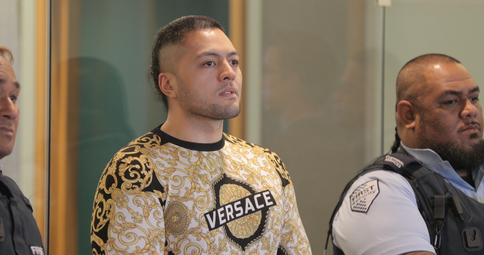 Tyson Daniels, vice president of the Comanchero MC, wears a designer Versace top in his gang colours at sentencing. Photo / Michael Craig