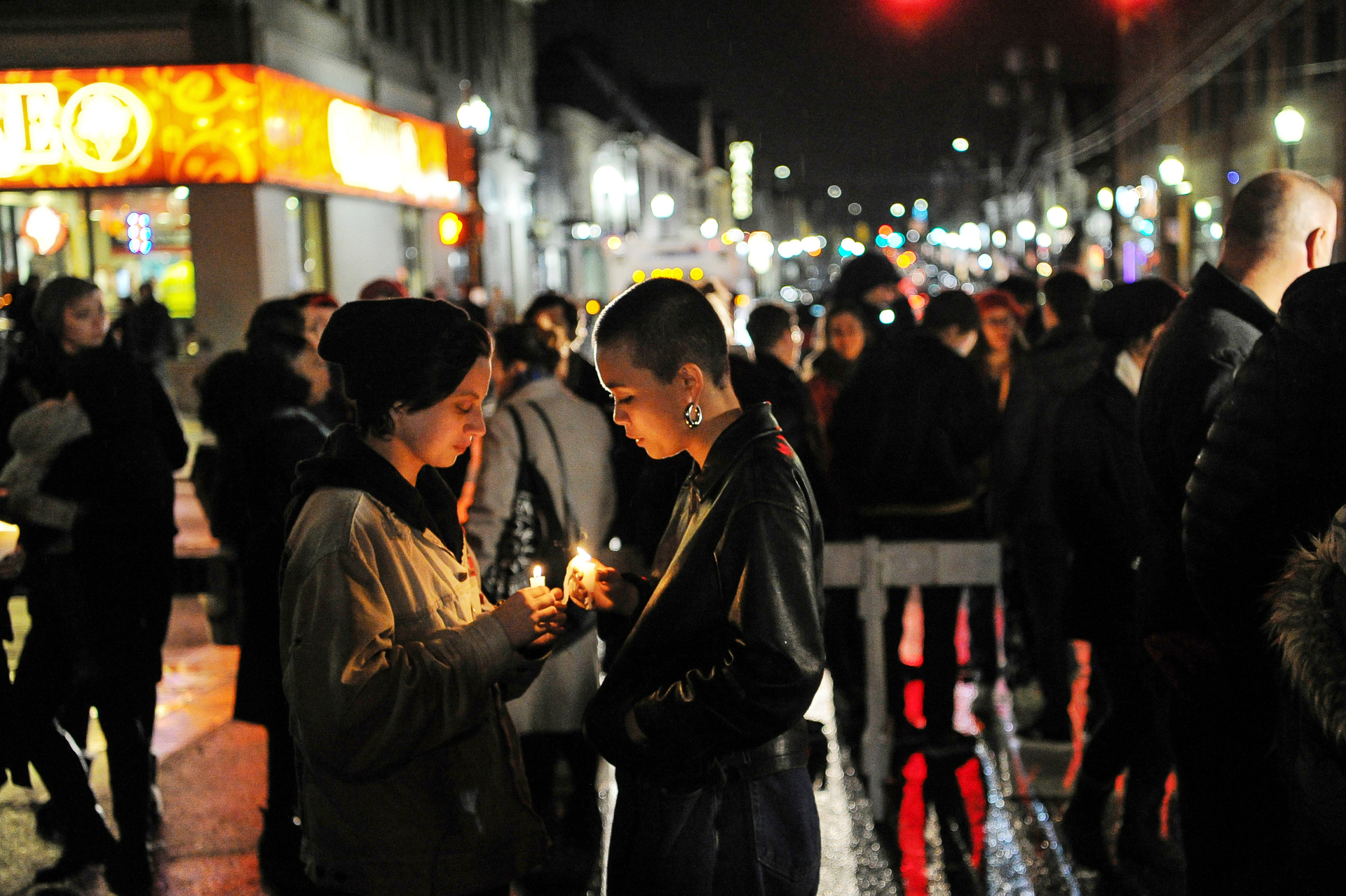 Rosie Villano, left, and Chai Smith hold candles during an interfaith vigil outside of Sixth Presbyterian Church in the Squirrel Hill. Photo / AP