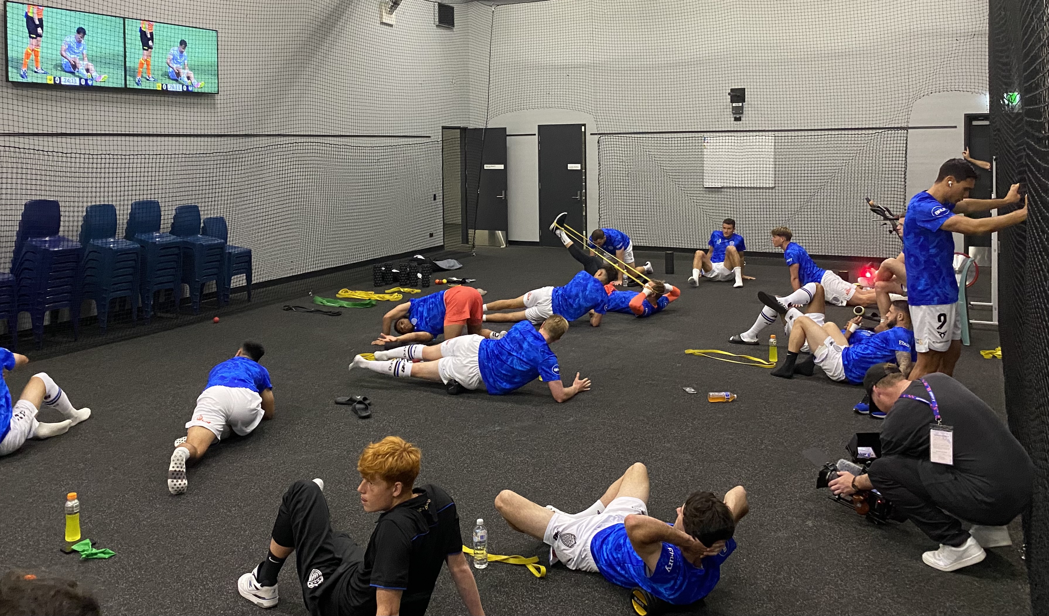 The players stretch pre-match. Photo / Michael Burgess