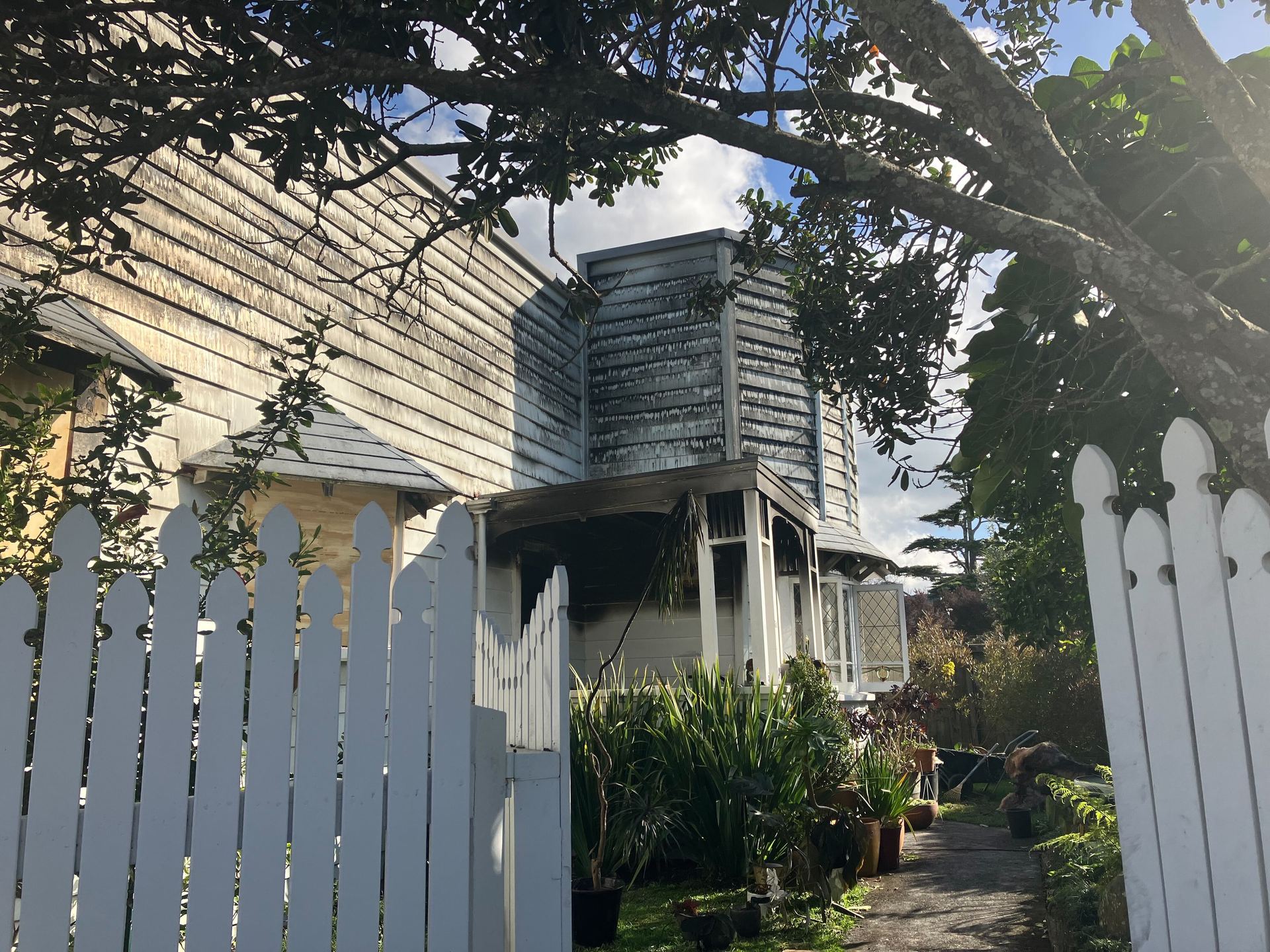 Contractors were working to stabilise the badly fire-damaged property yesterday afternoon. Photo / Rachel Maher