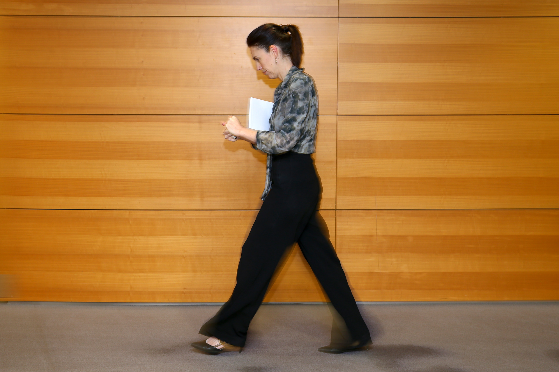 Prime Minister Jacinda Ardern rubbing hand sanitiser on her hands as she leaves a Covid-19 press conference. Photo / Mark Mitchell