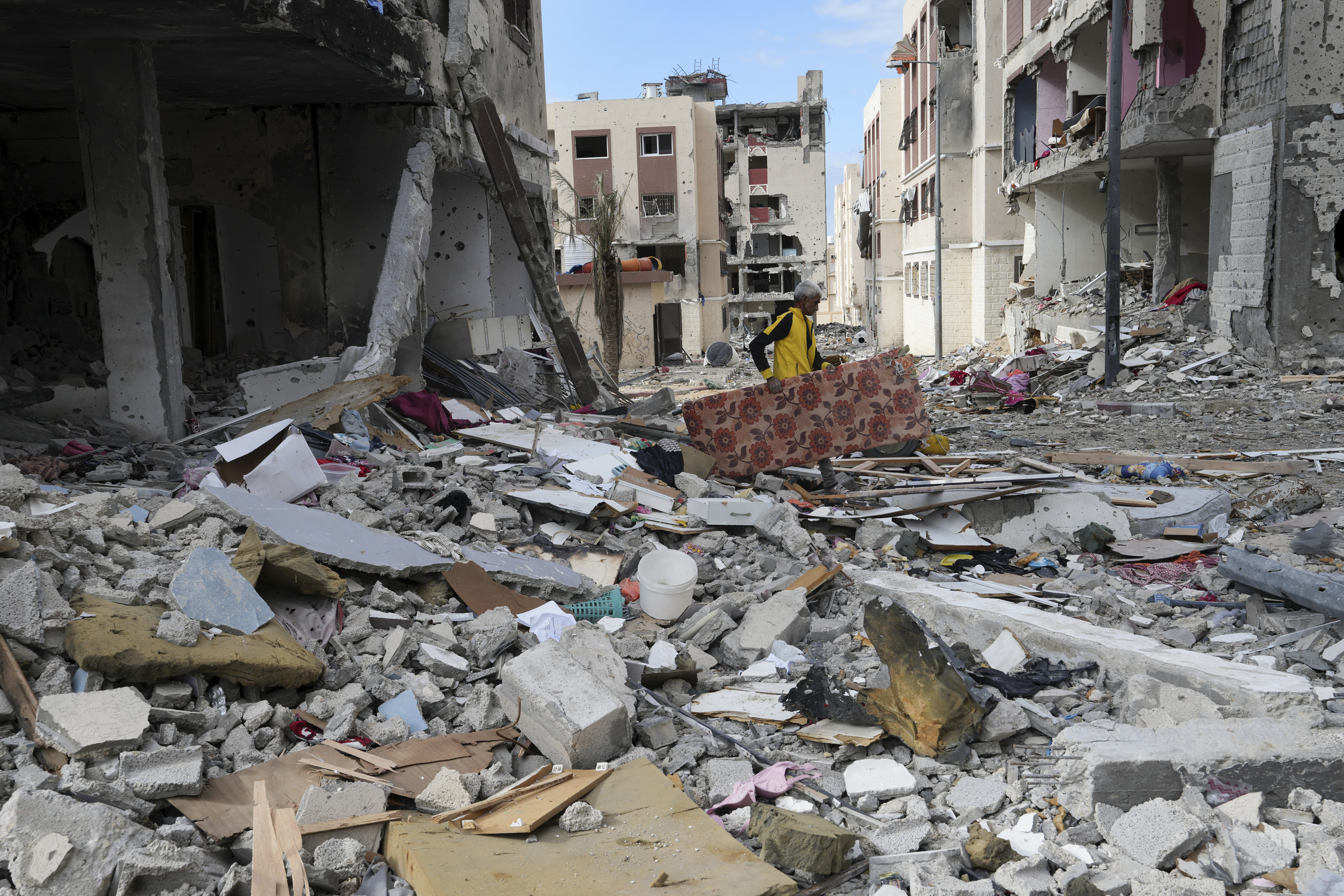 A Palestinian man collects his belongings southeast of Gaza City. Photo / AP