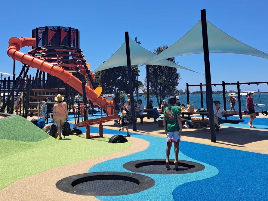 Reggie Willock, 3, from Gisborne (in centre of image) running through the new Tauranga waterfront playground. Photo / Sandra Conchie