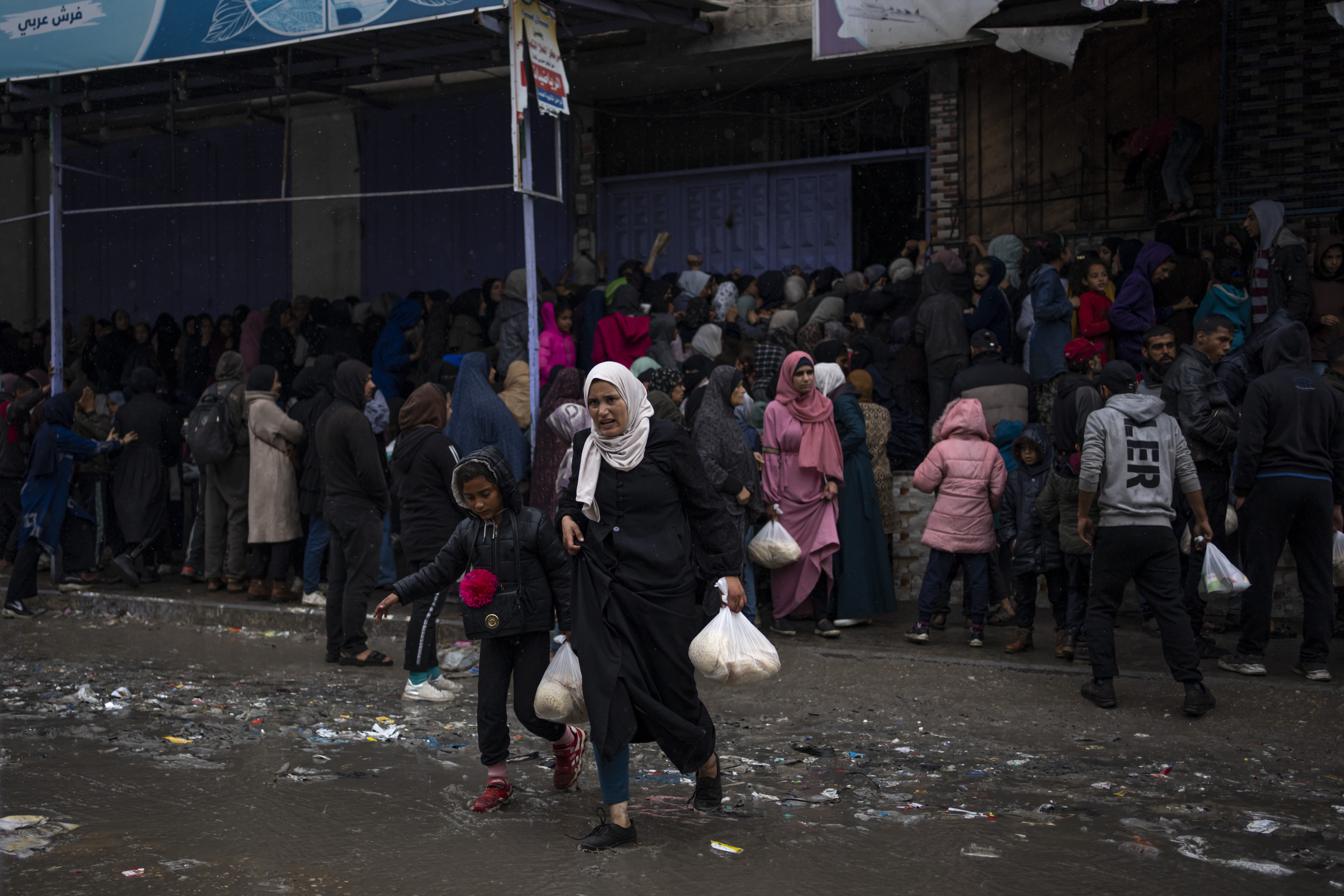 Palestinian crowds struggle to buy bread from a bakery in Rafah, Gaza Strip on Sunday, February 18, 2024. International aid agencies say Gaza is suffering from shortages of food, medicine and other basic supplies as a result of the war between Israel and Hamas. AP Photo / Fatima Shbair