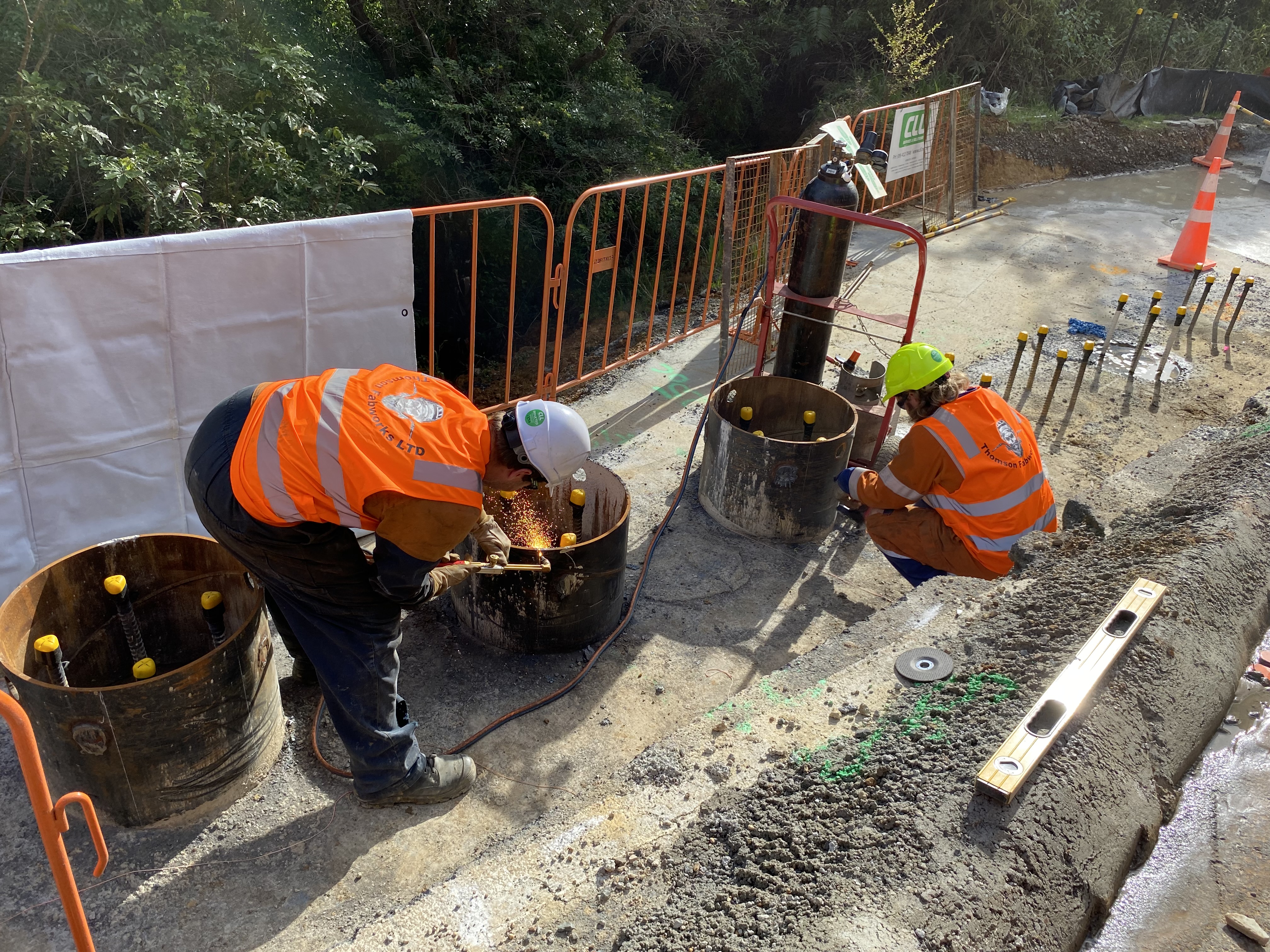 Callum Mullins (left) and Dale Thomson working on the piles intended to secure the earth on which the road will sit to the hillside. Photo / David Fisher