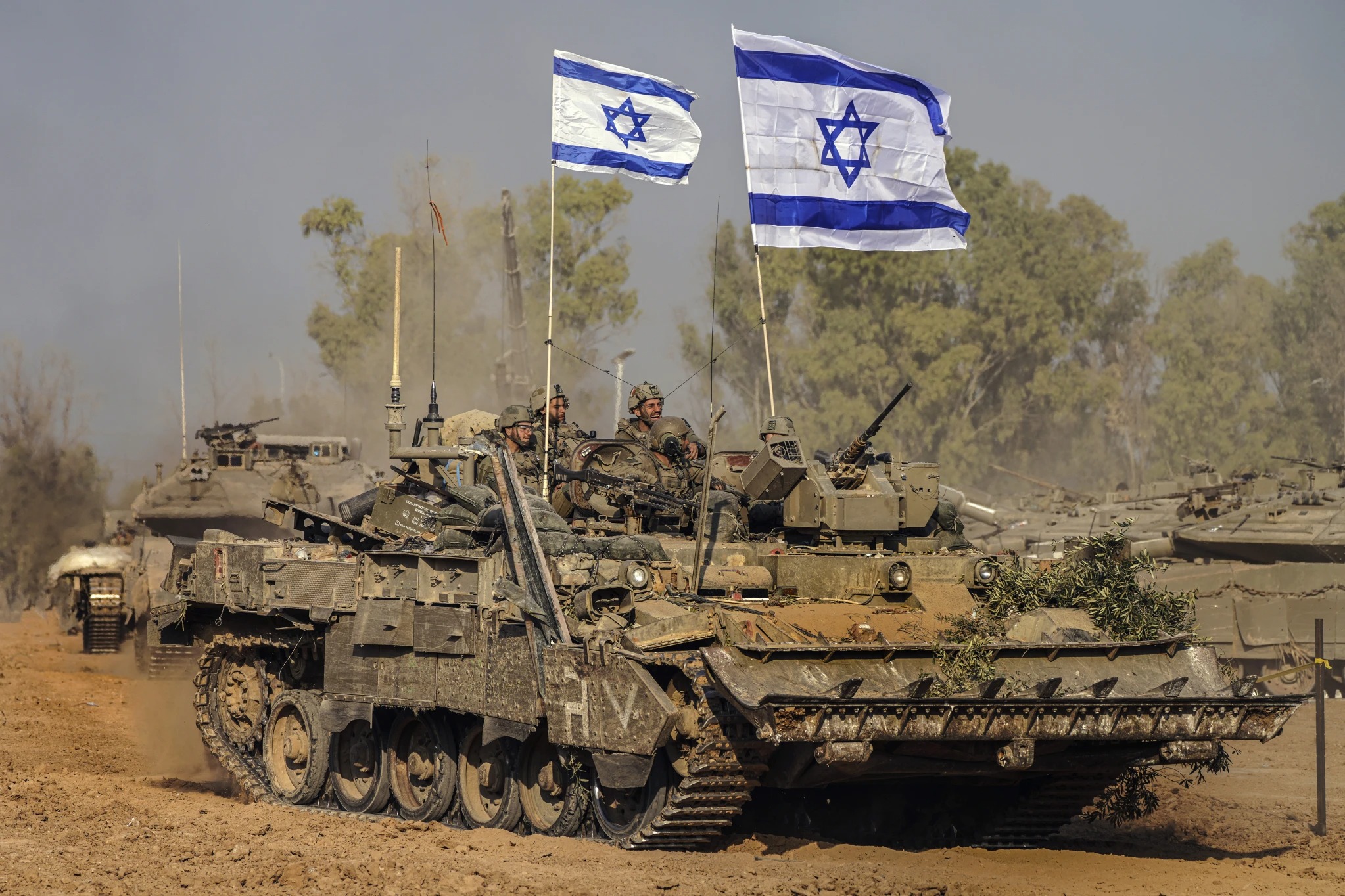 Israeli army vehicles arrive at a staging area after combat in the Gaza Strip in Southern Israel. Photo / AP 