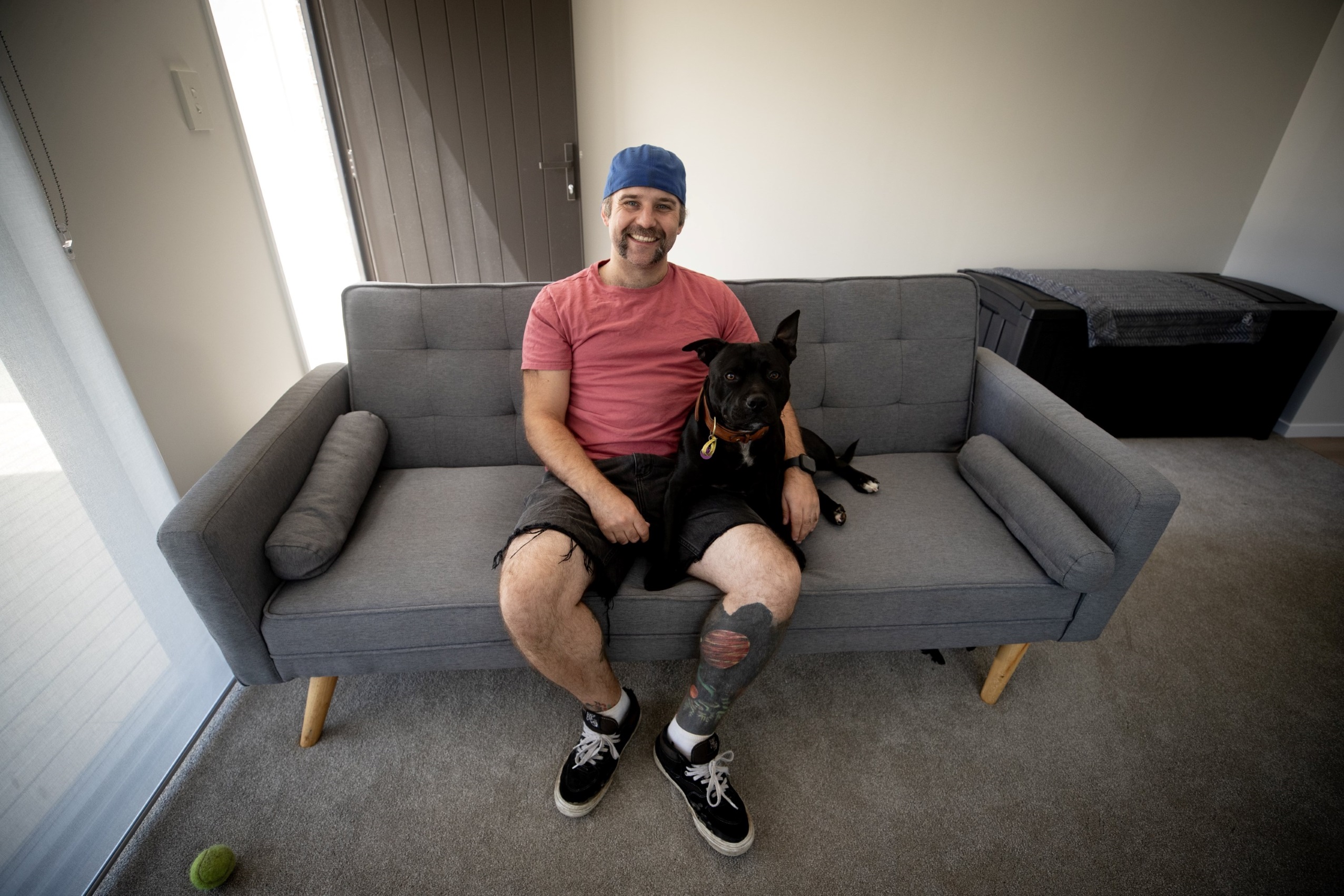 Harley Neville, pictured with dog Buddy, and his brother bought a KiwiBuild home in Auckland for $700,000 in January. Photo / Dean Purcell