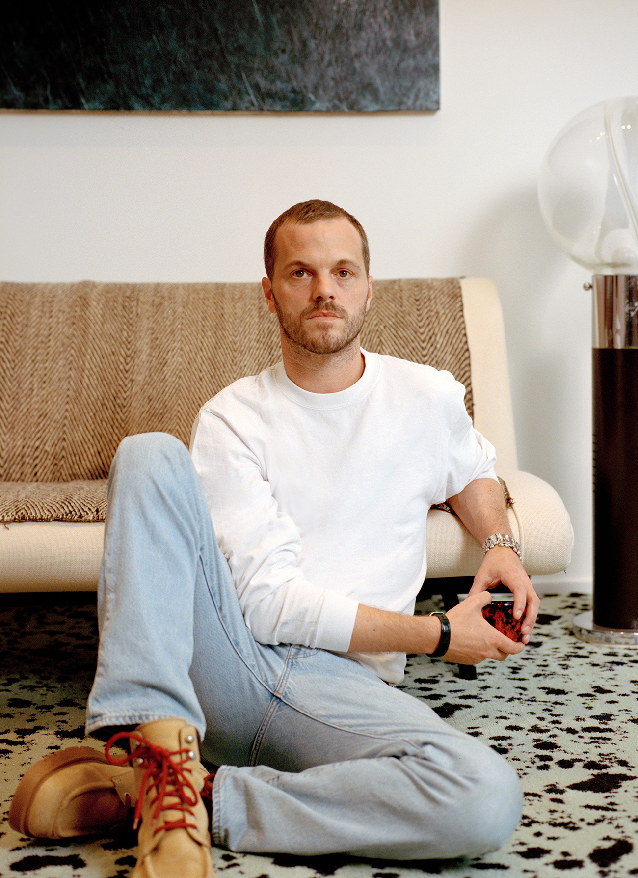 Matthieu Blazy, the creative director of Bottega Veneta, at his office in Milan. His rug was custom-made to resemble stracciatella, his favourite icecream. Photo / Carmine Romano, The New York Times