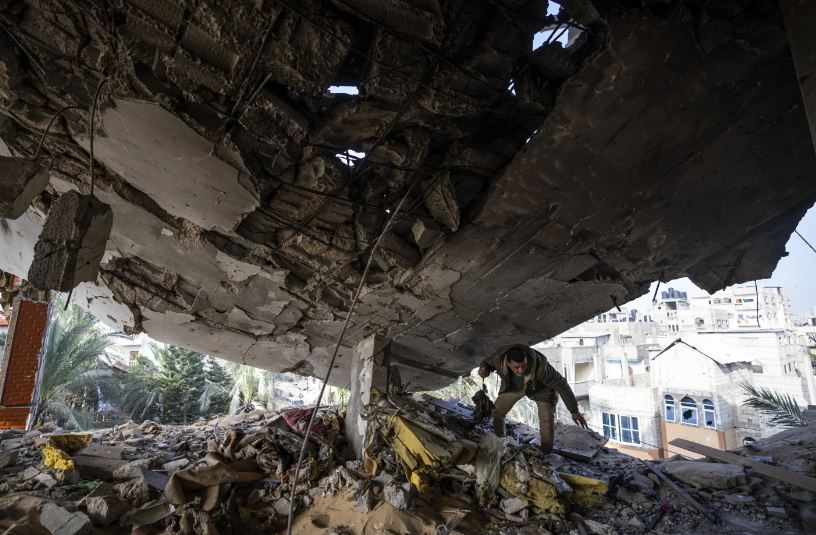 A Palestinian salvages belongings after an Israeli strike in Rafah, Gaza Strip. Photo / AP