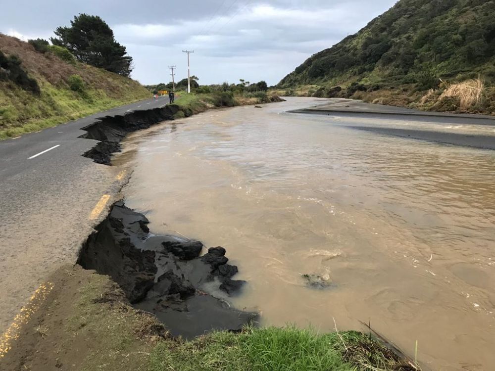 A section of Bethells Rd is washed out following flooding in West Auckland. Photo / Supplied