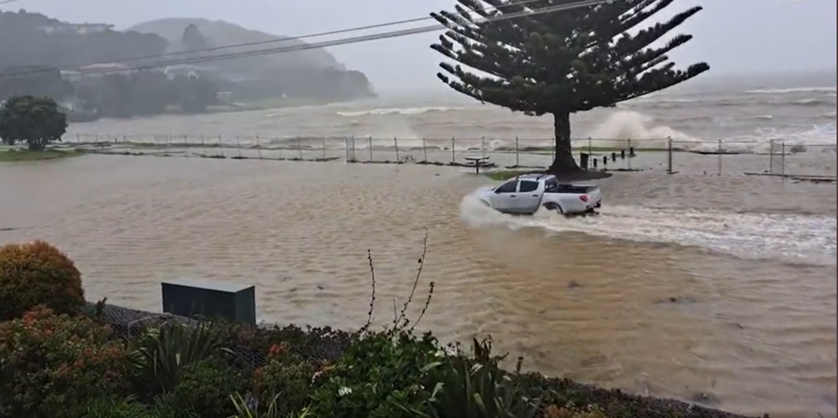 A ute drives through floodwaters rising in Whitianga, Coromandel as Cyclone Gabrielle arrives in New Zealand. Photo / Supplied