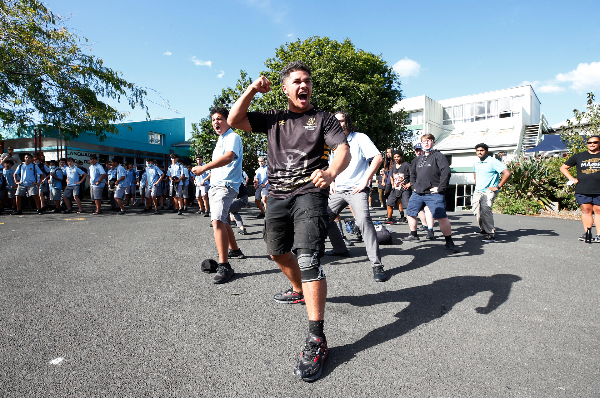 Students and staff gathered at the 'Quad' for karakia, waiata, and a mass haka led by head boy Tane Marsters on the last day in the old Whangarei Boys' High School building. Photo / Michael Cunningham