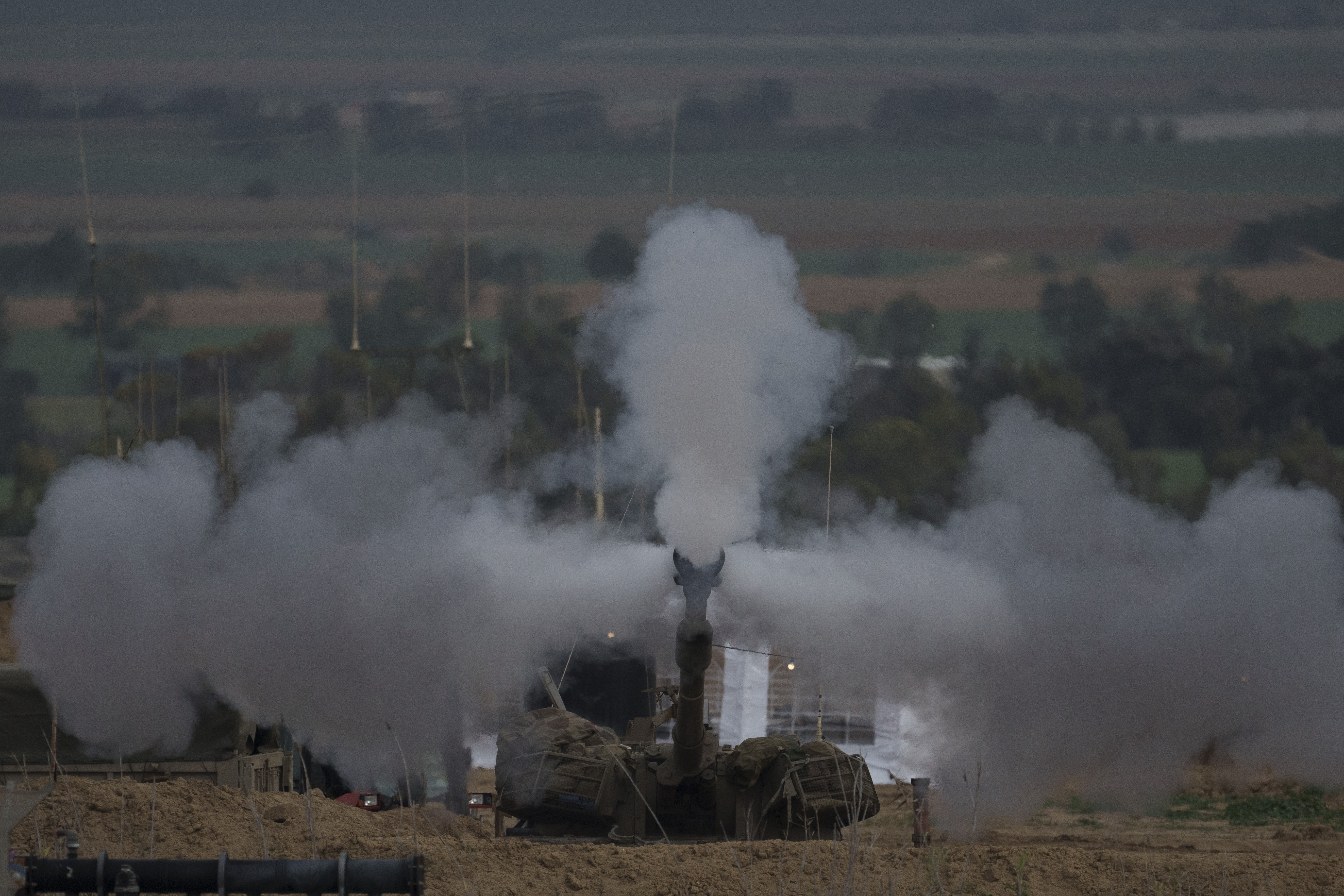 An Israeli mobile artillery unit fires a shell from southern Israel towards the Gaza Strip, in a position near the Israel-Gaza border. Photo / AP