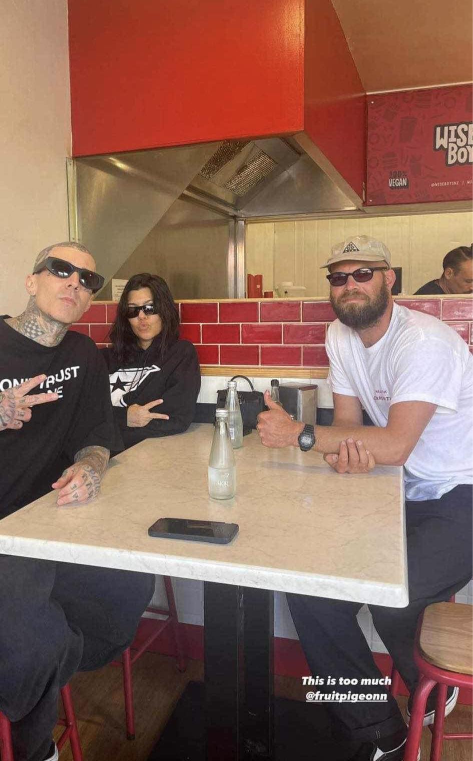 A-lister couple Travis Barker and Kourtney Kardashian posing with a customer at Wise Boys Grey Lynn.