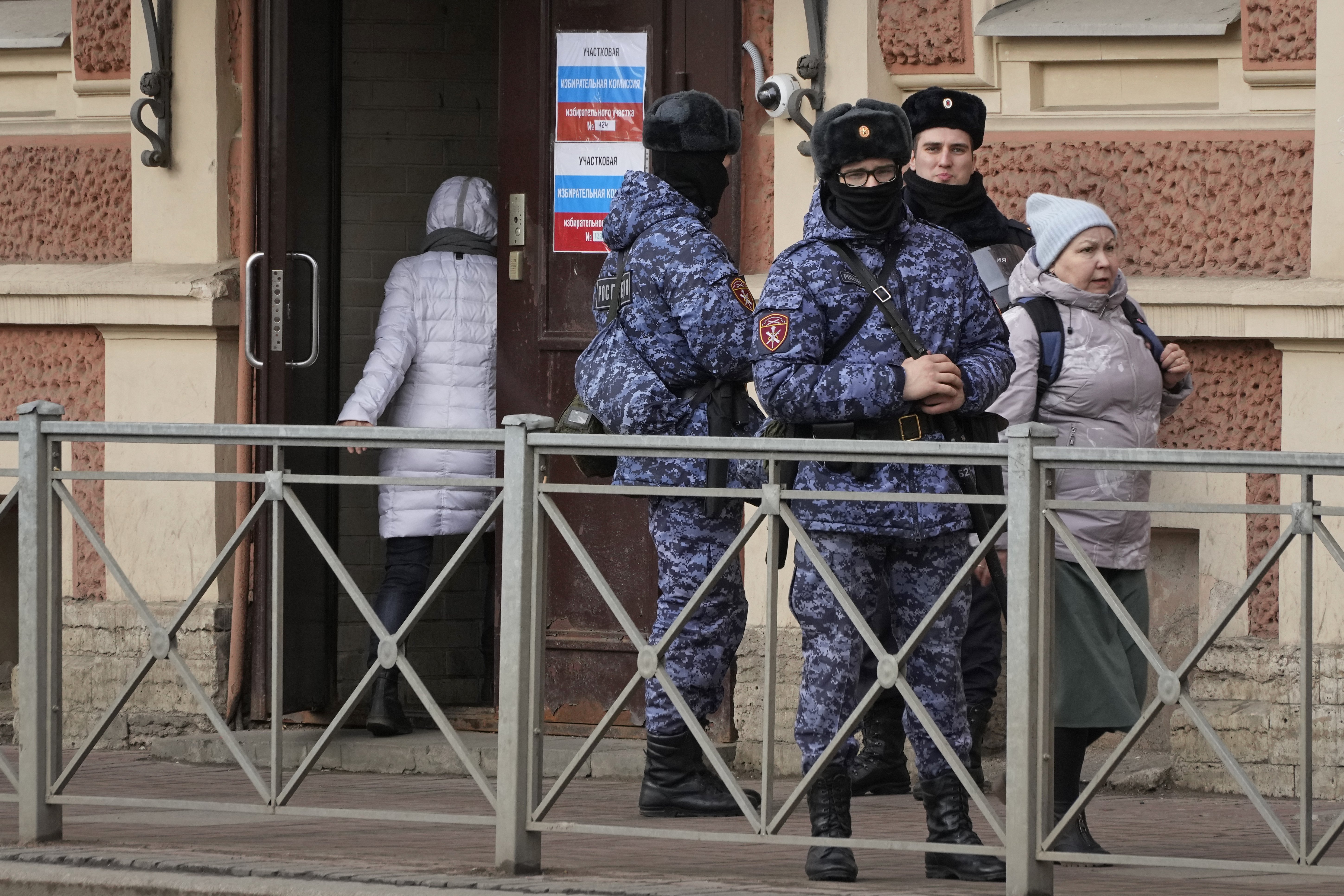 Russian Rosguardia (National Guard) servicemen stand guard at a polling station during the presidential elections in St Petersburg. Photo / AP