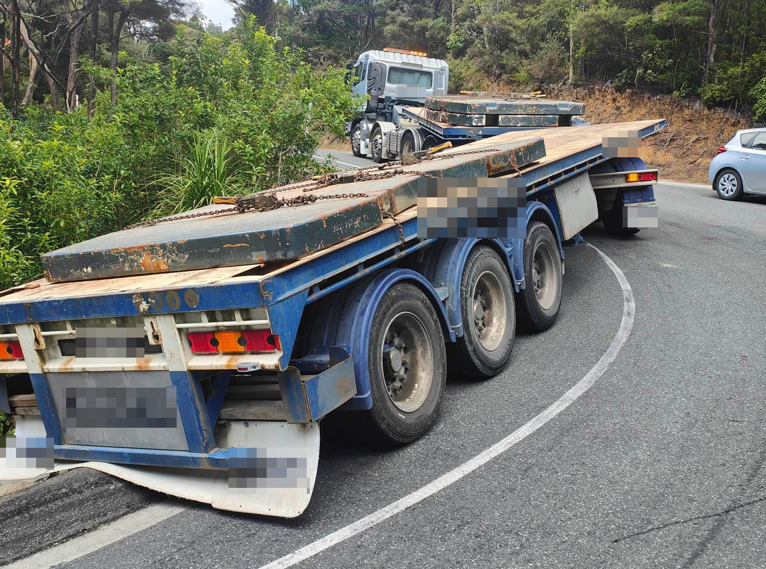 The truck and trailer unit stuck on a bend on Cove Rd. Photo / Supplied