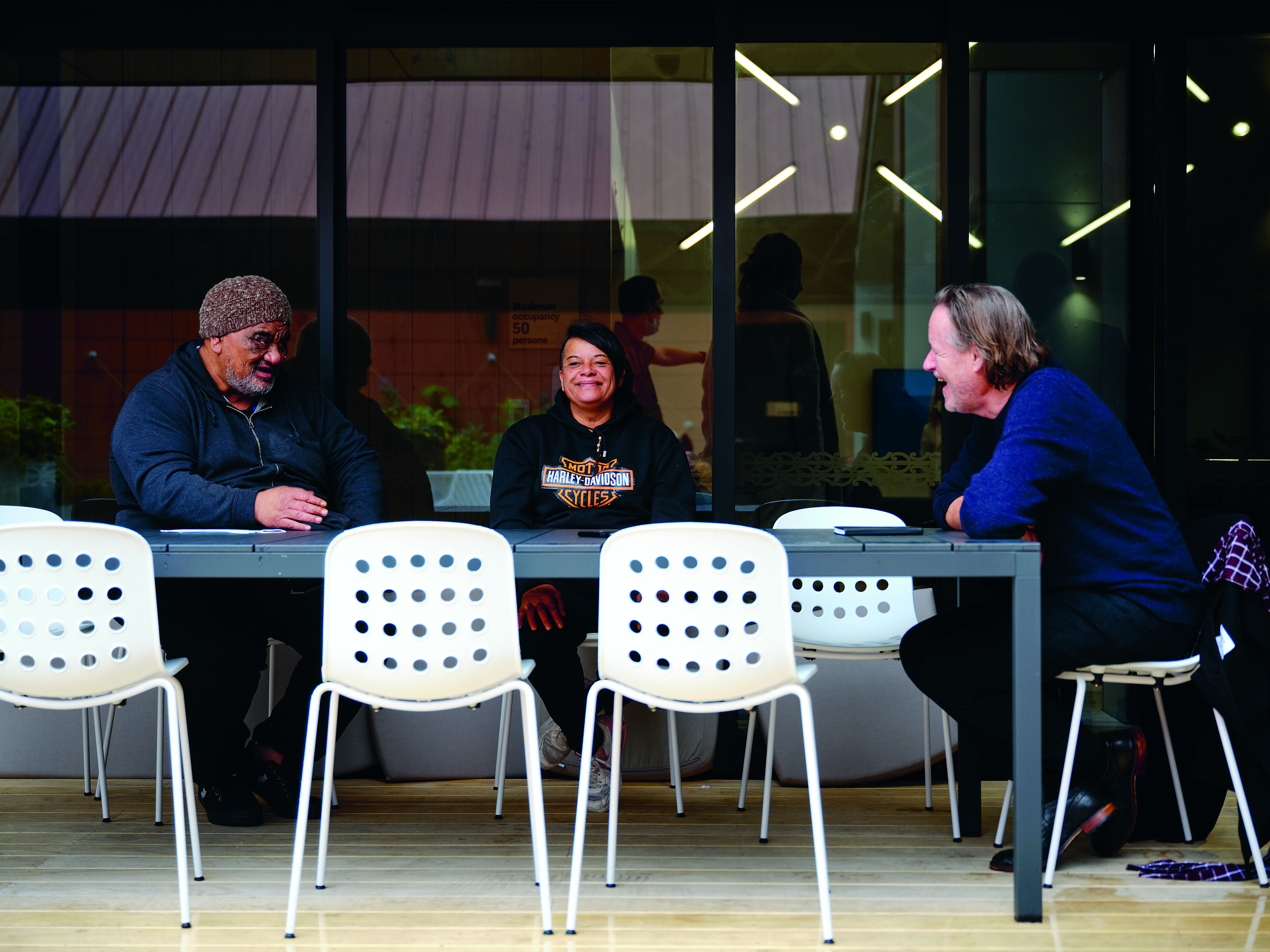 Residents Ivan Tepu (Ngāti Rereahu) and Lisa-Marie Peerdemen (Ngāpuhi) with the book's author, Simon Wilson. Photo / Mark Smith