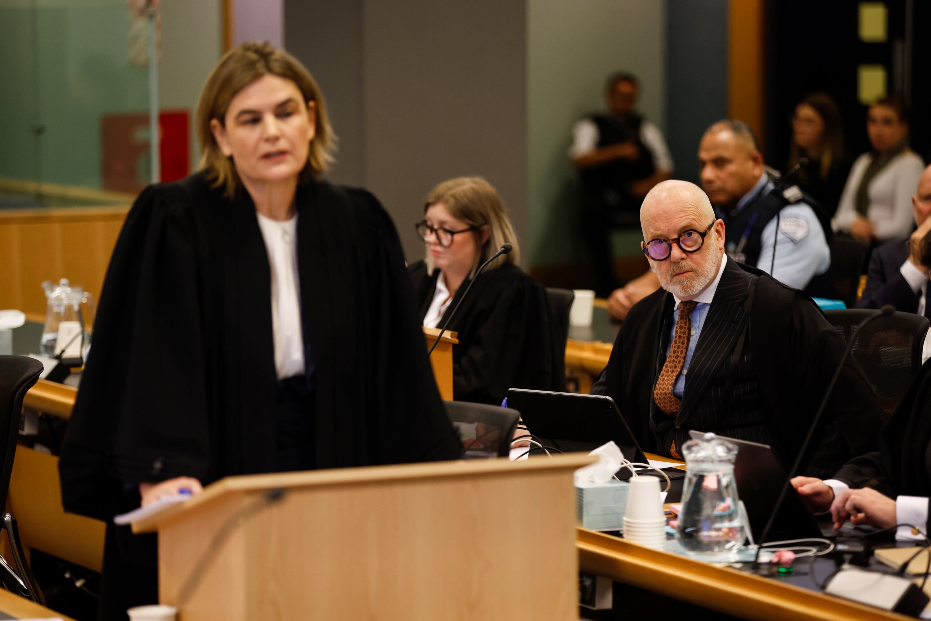 Crown Solicitor Alysha McClintock addresses jurors in the murder trial of Philip Polkinghorne while defence lawyers Ron Mansfield and Hannah Stuart listen in the background. Photo / Michael Craig