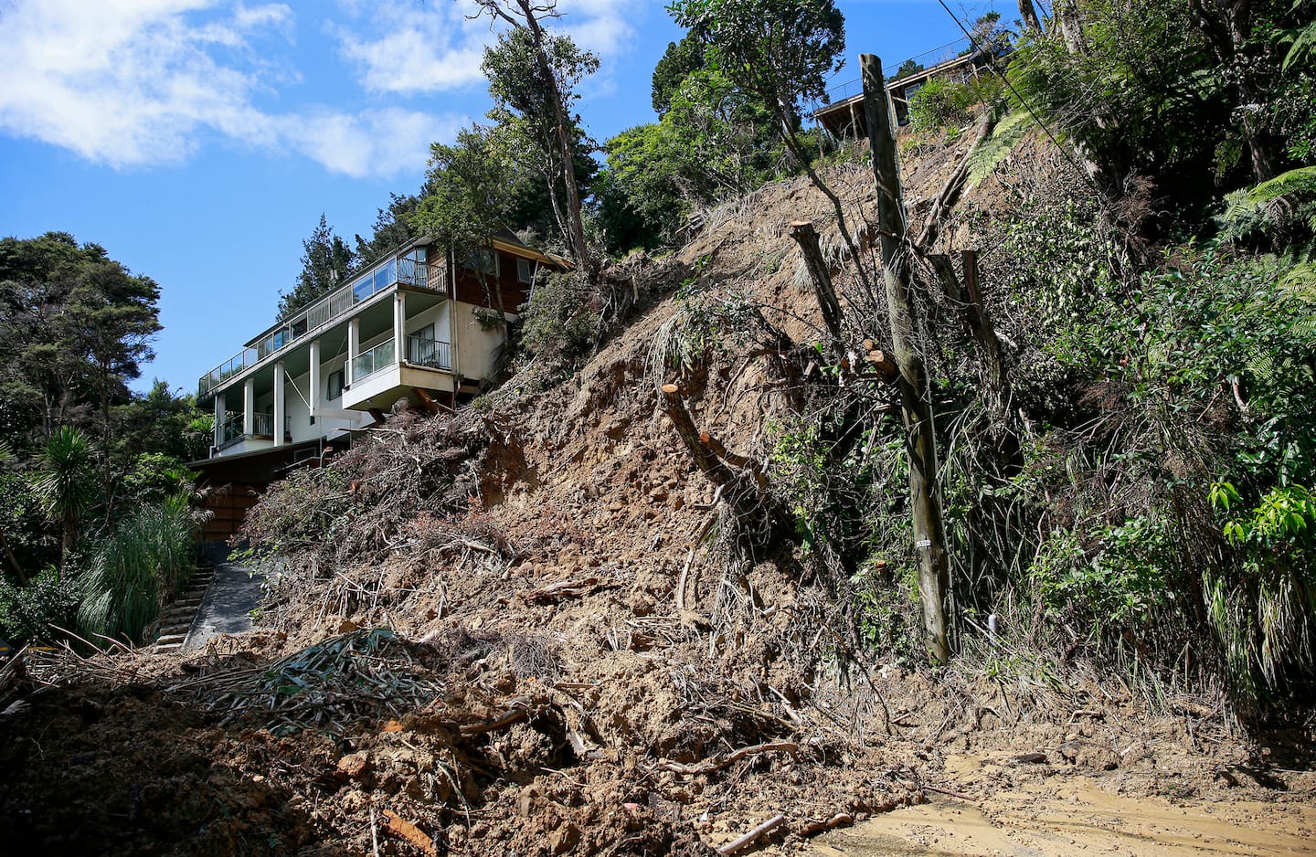 A storm-damaged home in West Auckland. Photo / Alex Burton