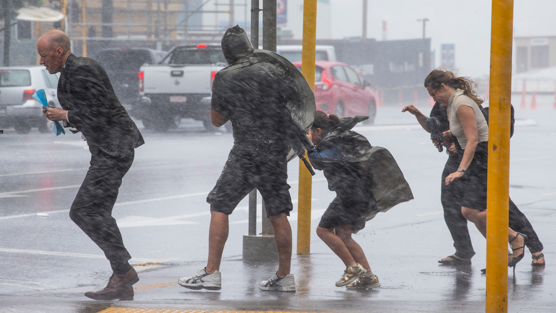 Pedestrians battle wild weather delivered with the remnants of Cyclone Fehi in February 2018. Photo / Mark Mitchell