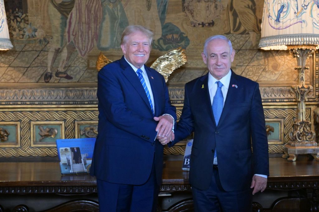 Former US President Donald Trump shakes hands with Israeli Prime Minister Benjamin Netanyahu as they pose for a photo within their meeting at Mar-a-Lago estate, in Palm Beach, Florida. Photo / Amos Ben-Gershom (GPO) / Handout/Anadolu via Getty Images