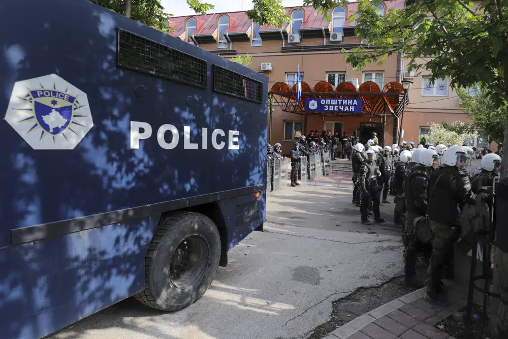Polish soldiers, part of the peacekeeping mission in Kosovo KFOR, right, and Kosovo police officers guard a municipal building in the town of Zvecan, northern Kosovo. Photo / AP