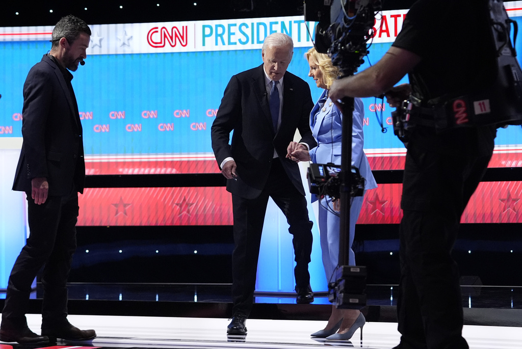 US President Joe Biden is helped off the stage by first lady Jill Biden after a halting debate performance against his rival Donald Trump. Photo / AP