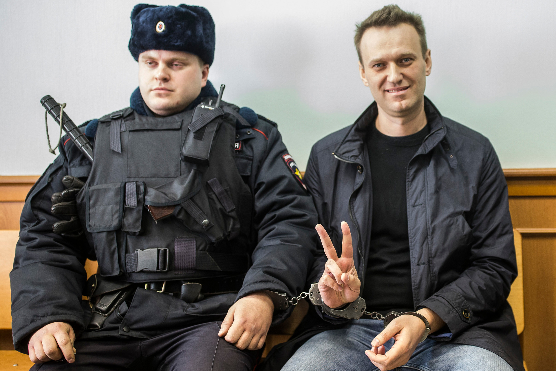 Navalny shows a V-sign for the media in court in Moscow. Photo / AP