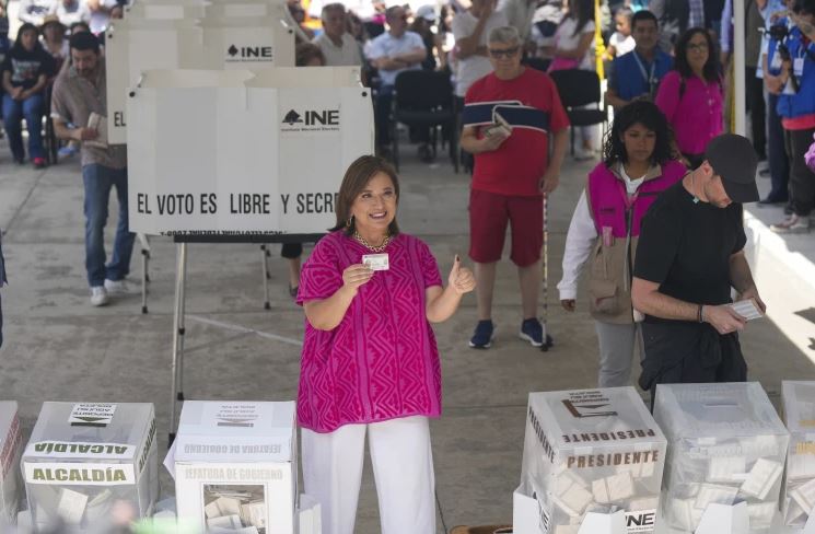 Opposition presidential candidate Xóchitl Gálvez shows her ink-stained thumb and her ID after voting in the general election in Mexico City. Photo / AP