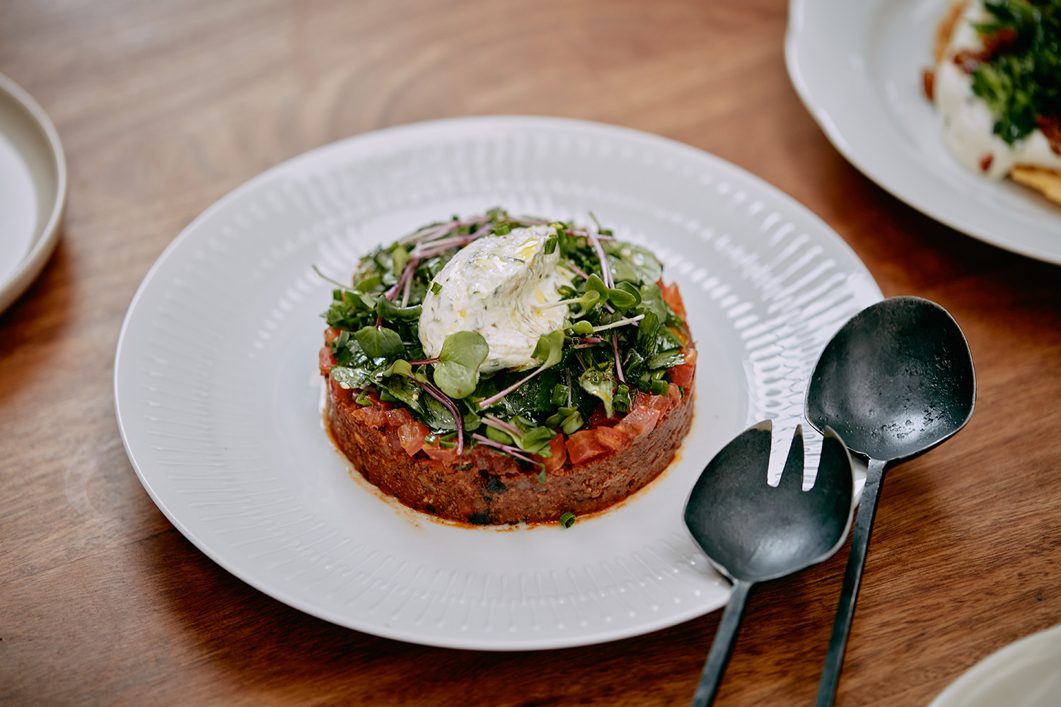 The flat kibbeh with smoked harissa lamb and compressed tomatoes. Photo / Babiche Martens