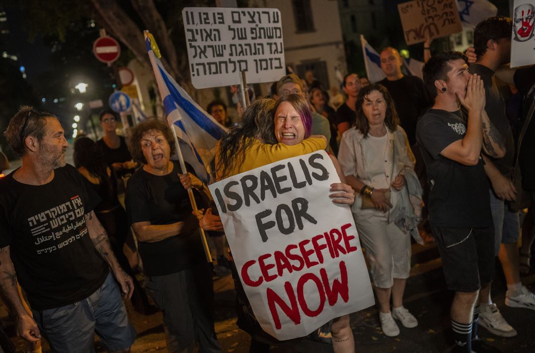 An Israeli woman calling for a ceasefire in the Gaza Strip is comforted by another protester after an argument with a right-wing Israeli in Tel Aviv, Israel. Photo / AP
