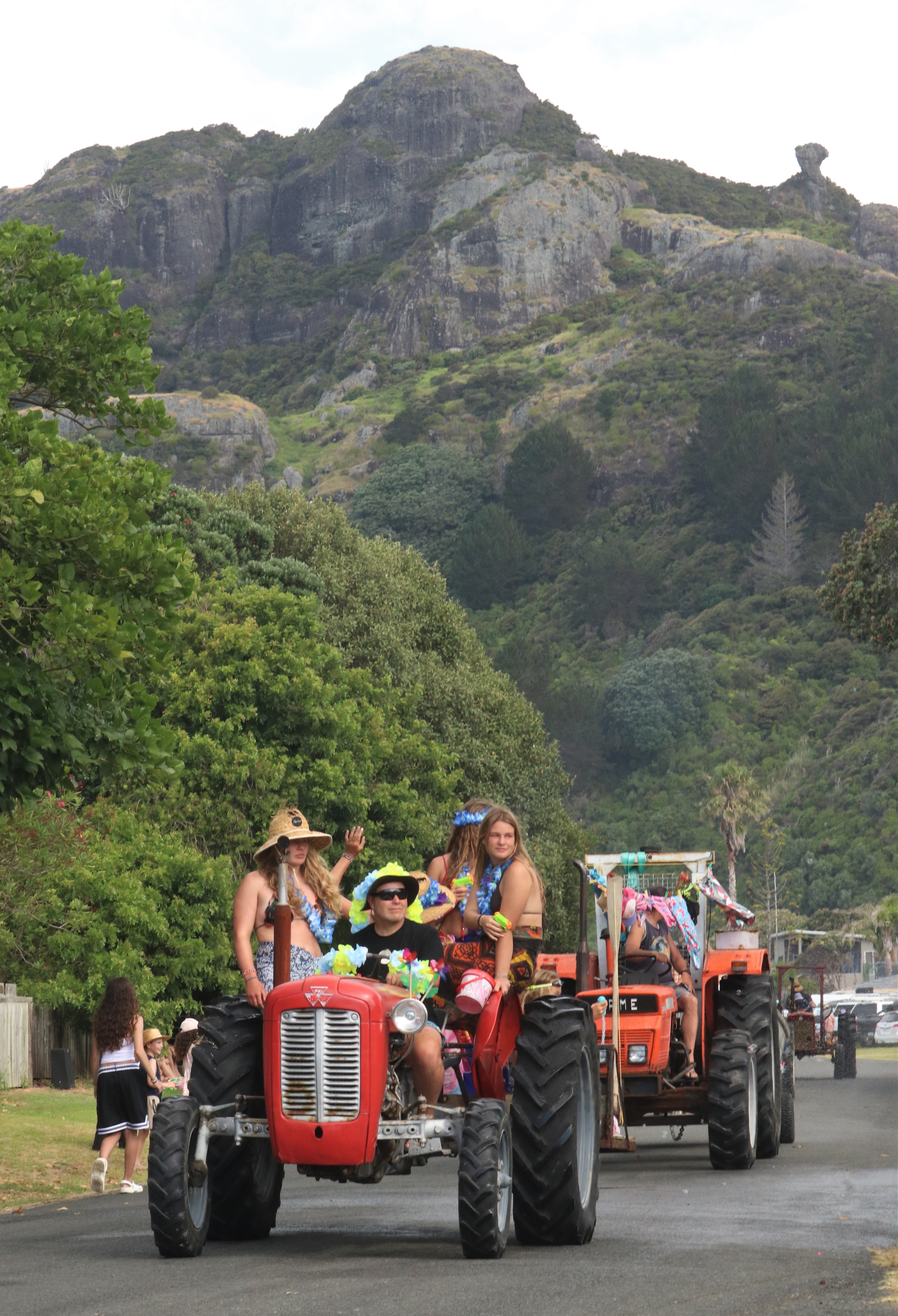 A team called Two Uglies, Five Beauties heads back up Taupō Bay’s main road. We’ll let you work out which is which. Photo / Peter de Graaf