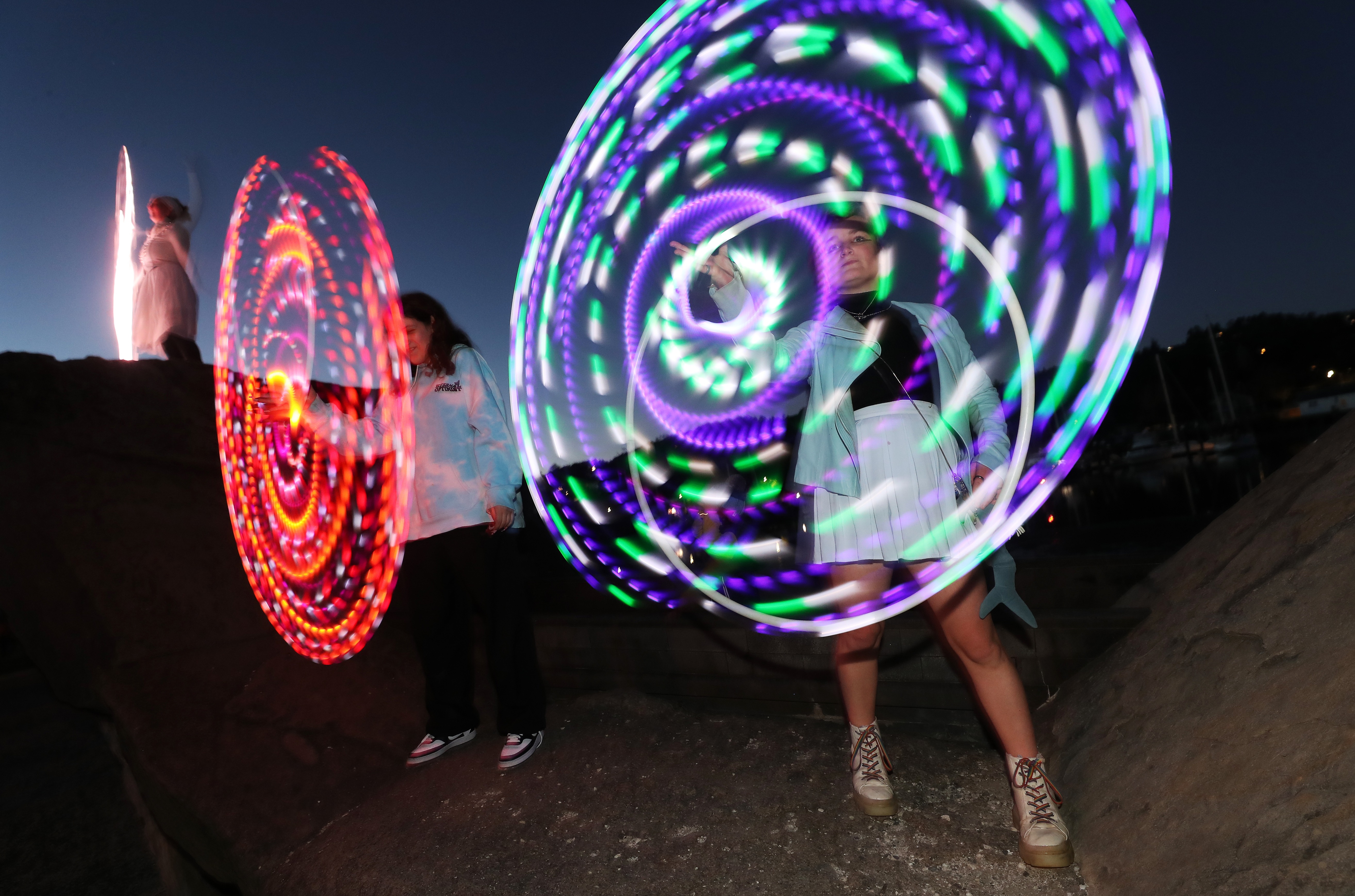 Lisa Lu, Savanah Erdos and Tiree Gilroy from Circus Kumarani add colour and lumination to the Light and Lantern Parade. Photo / Michael Cunningham