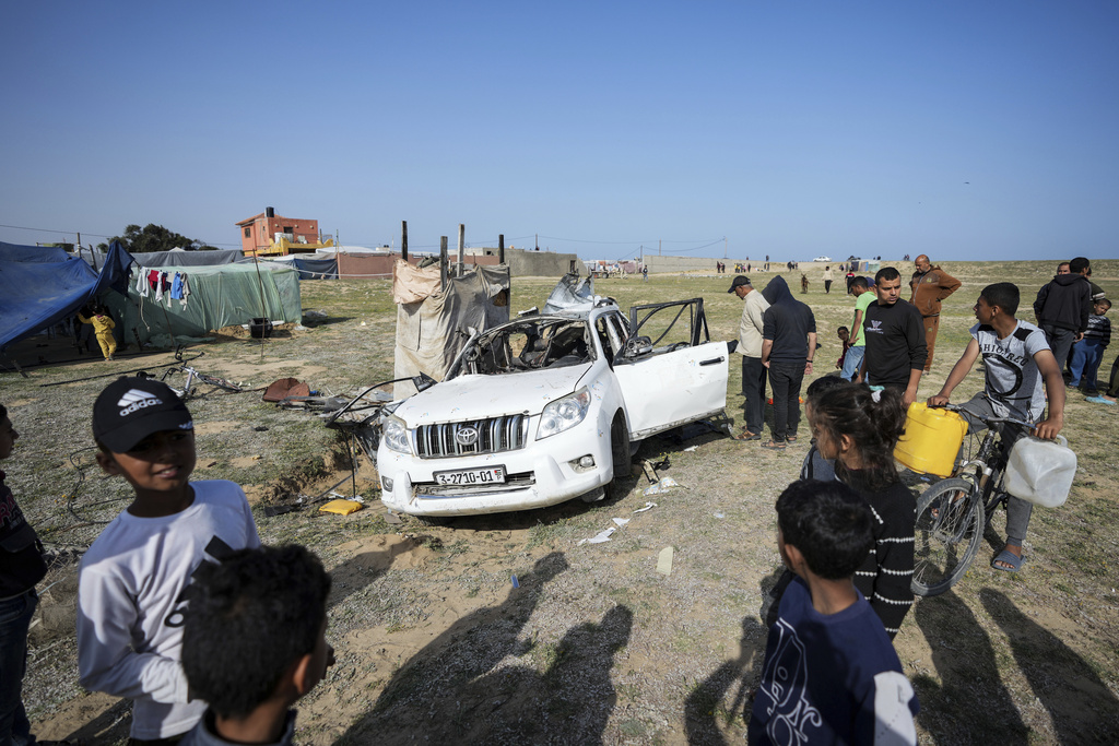 People inspect the site where one fo the World Central Kitchen vehicles was targetted by an Israeli drone strike. Photo / AP