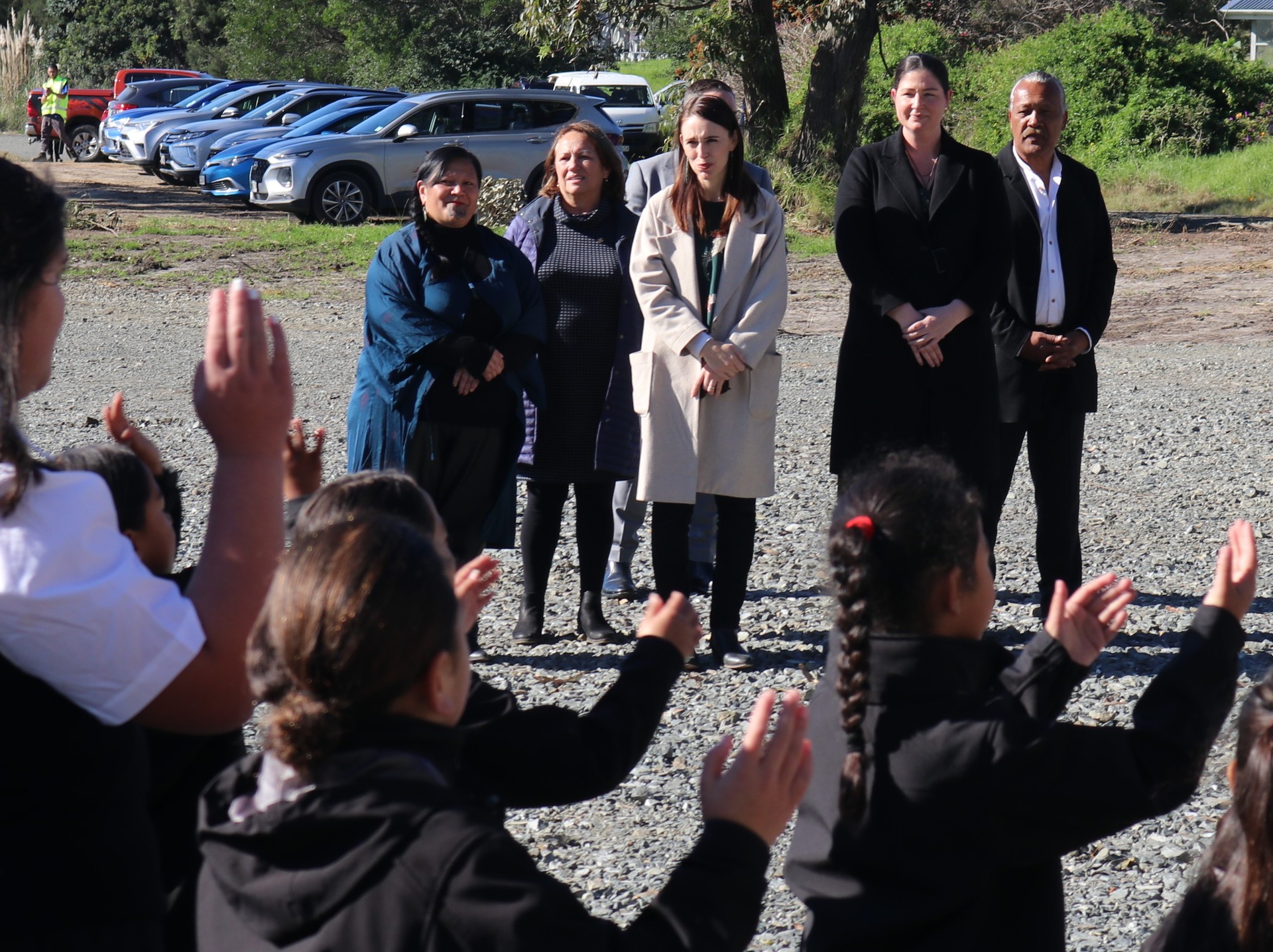 Children from Te Kura o Te Kao welcoming the Prime Minister to Pukenui with, from left, Te Rūnanga Nui o Te Aupōuri chief executive Mariameno Kapa-Kingi and chairwoman Rhonda Kite, Northland MP Willow-Jean Prime and Te Aupōuri elder Joe Conrad. Photo / Peter de Graaf