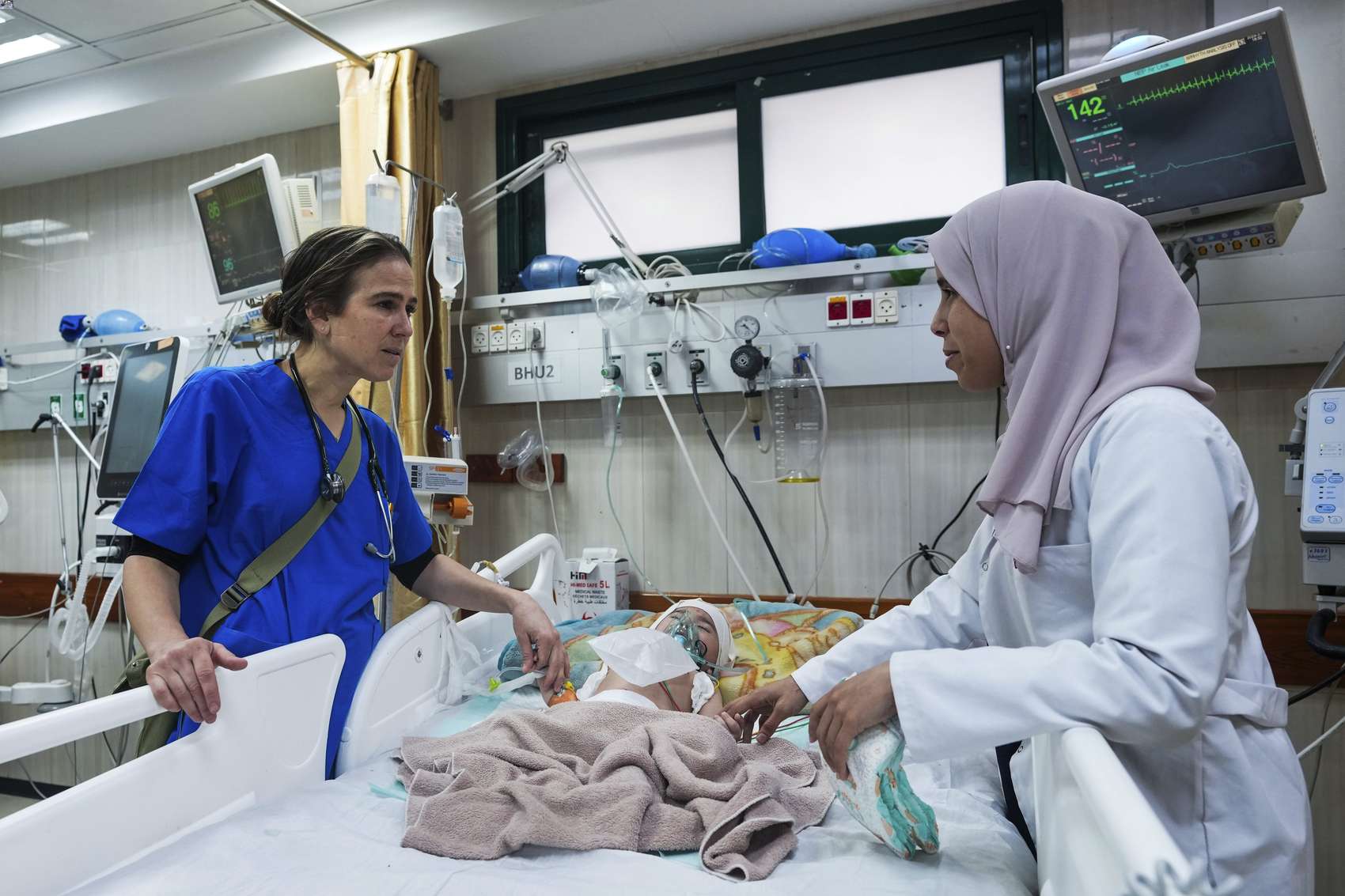 Paediatrician Tanya Haj-Hassan, left, examines wounded children at Al-Aqsa Martyrs Hospital. Photo / AP