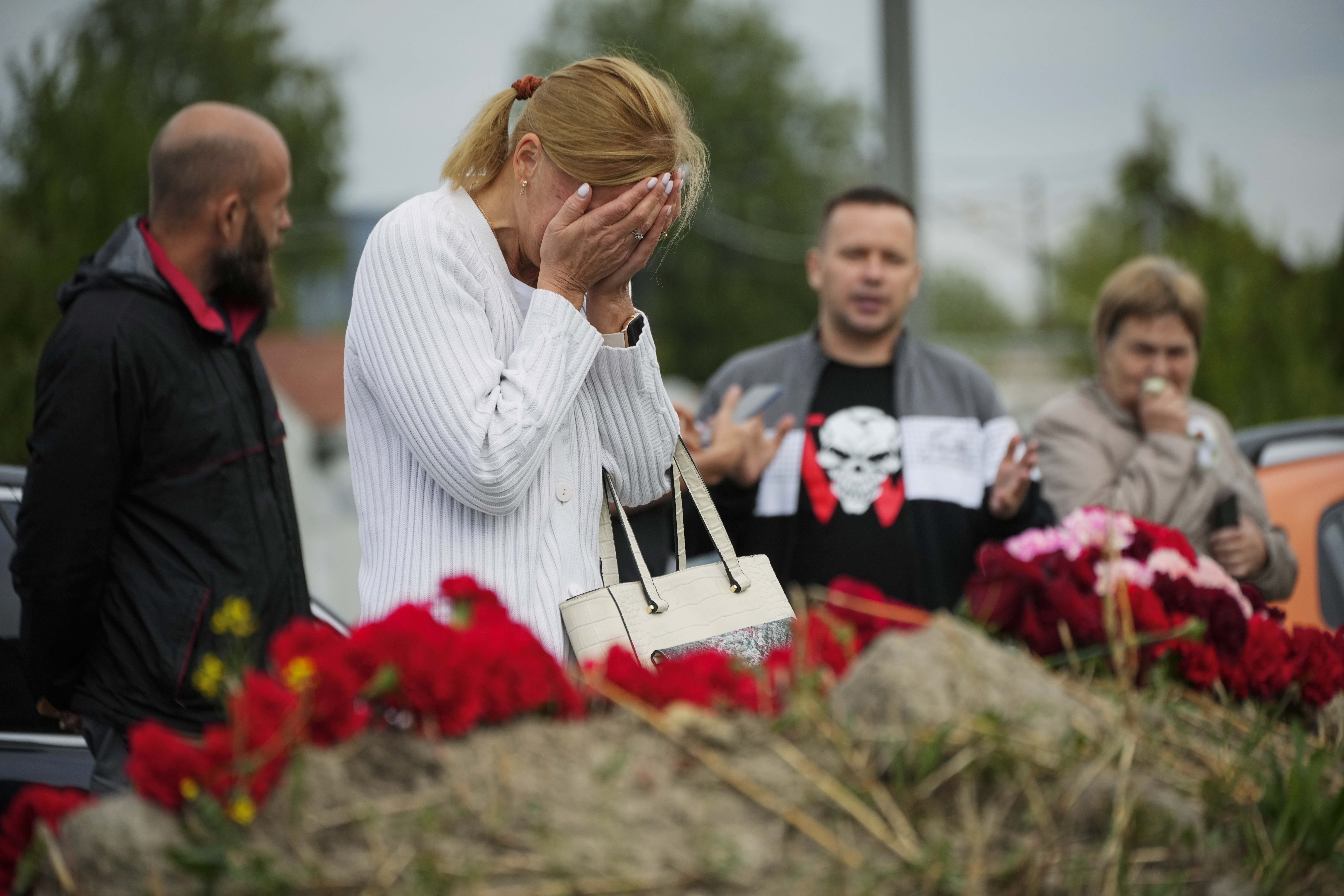 A woman reacts at an informal memorial next to the former 'PMC Wagner Centre' in St Petersburg, Russia. Photo / Dmitri Lovetsky, AP