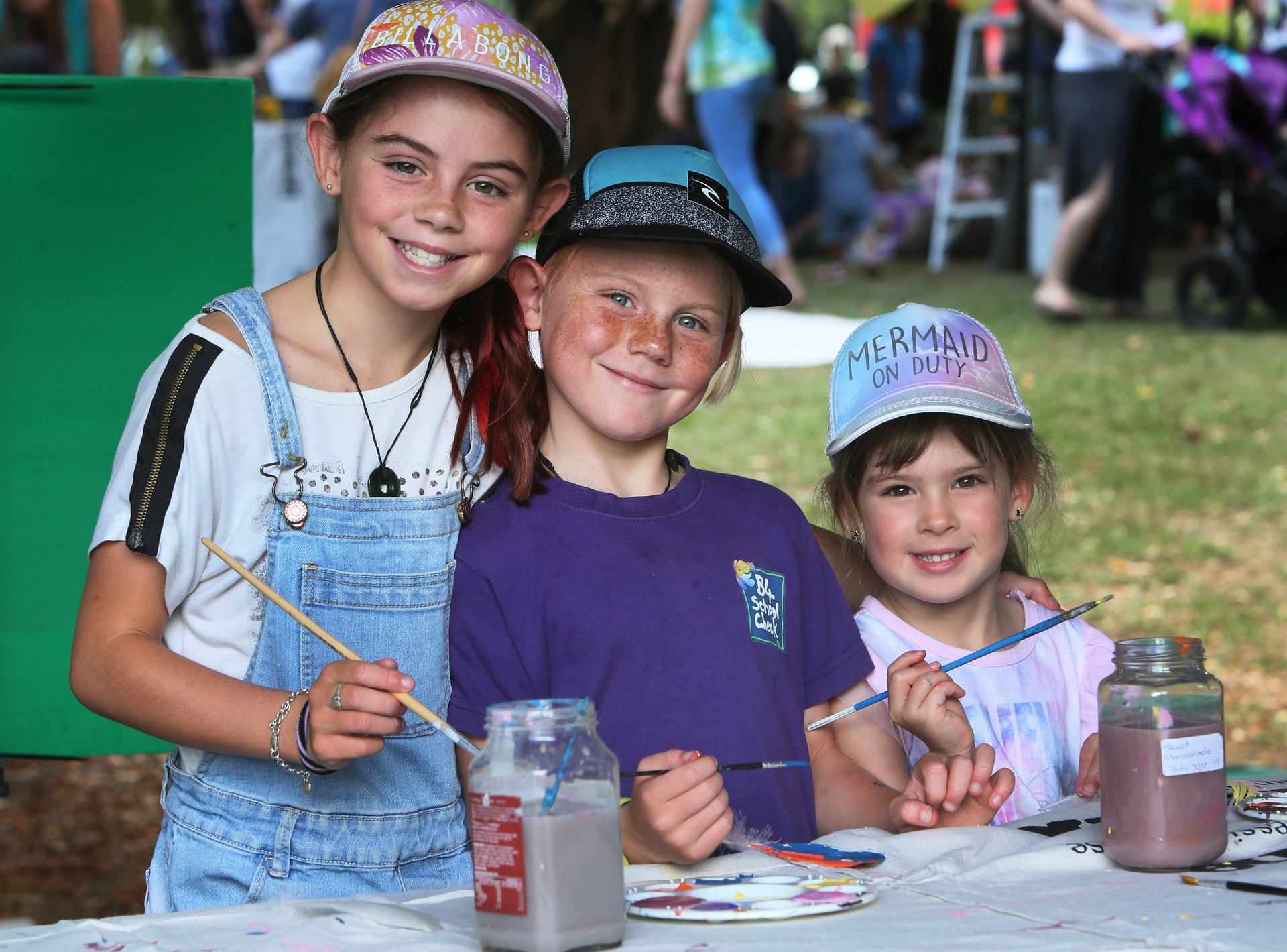 Painting feathers was fun for sisters Katy, 10, left, and Penny Gibbons, 7, and their cousin Andi McCollough, 5.