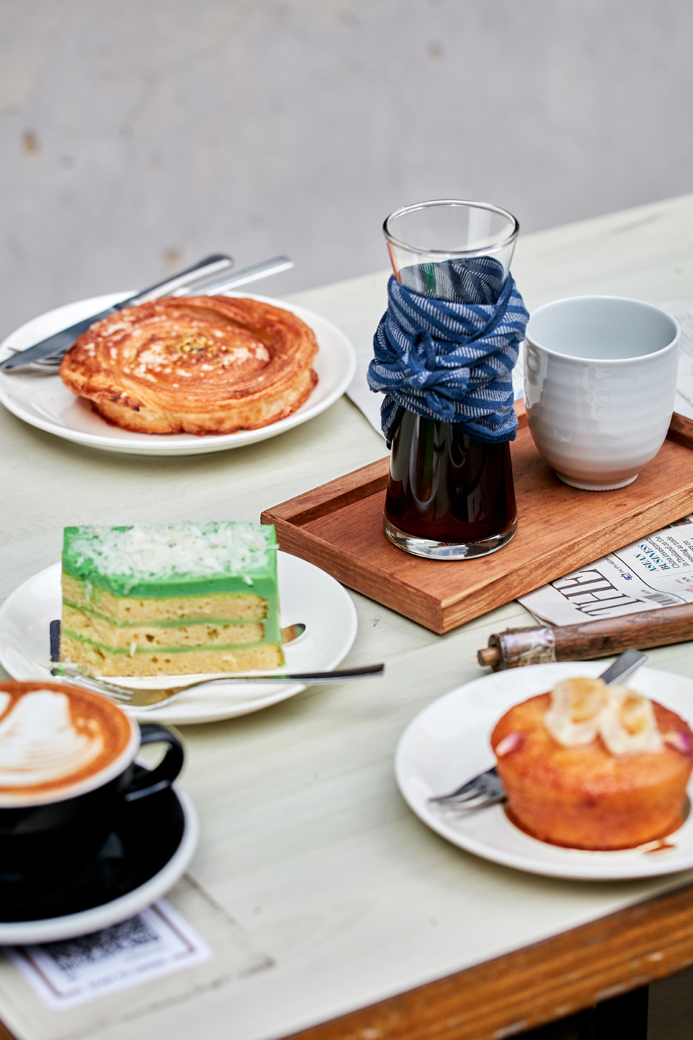 Coffee, pandan kaya cake, pastries and lychee cake at Chye Seng Huat Hardware cafe in Singapore’s Jalan Besar. Photo / Babiche Martens