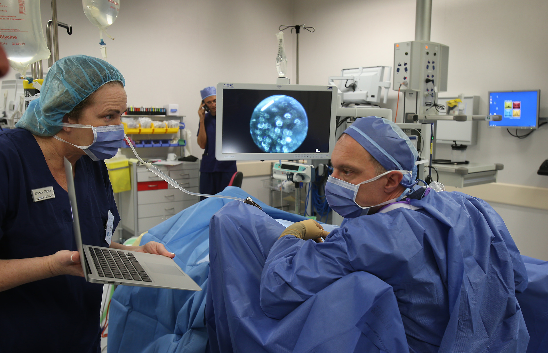 Surgeon Jim Duthie gets guidance from Henry Woo via Skype during a new surgical procedure, the Urolift Photograph by John Borren