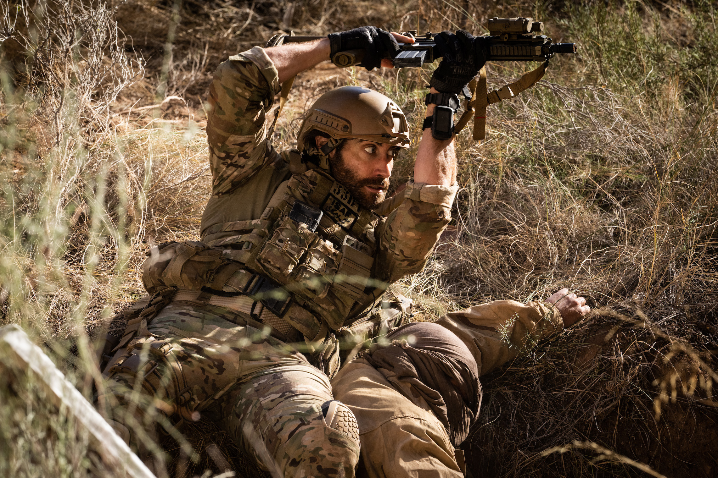 Jake Gyllenhaal under fire in the war drama Guy Ritchie's The Covenant. Streaming on Amazon Prime Video.