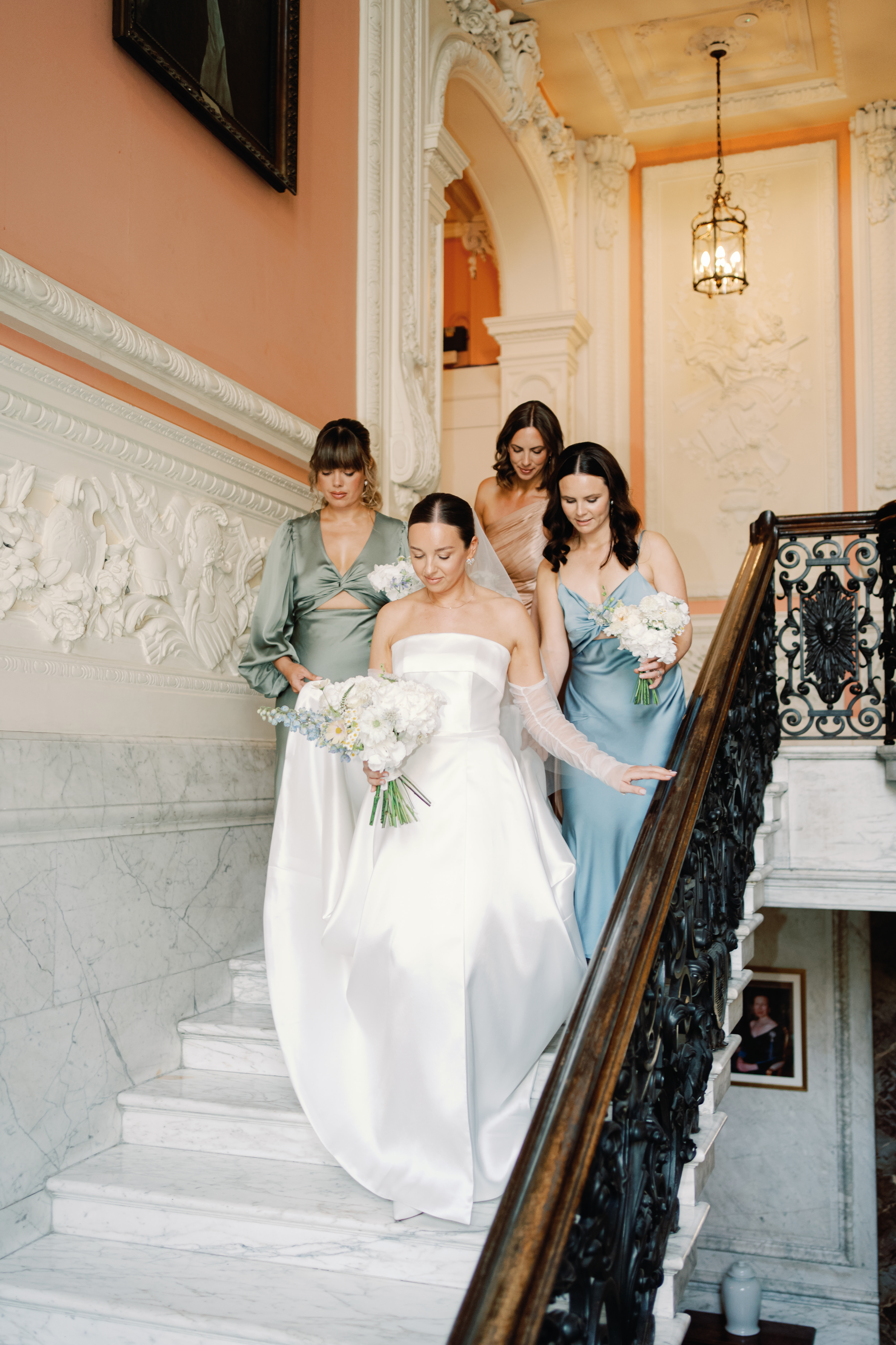 Yiselle descends the Dartmouth House stairs with her bridesmaids. Photo / Jessica Lily