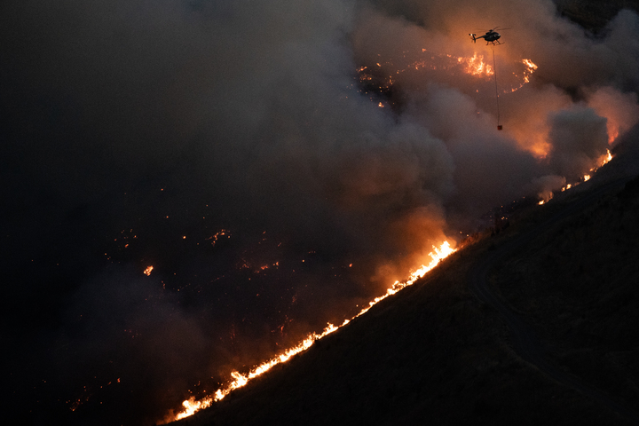 Helicopter crews battled the blaze until dark as the fire continued to burn in the Port Hills. Photo / George Heard