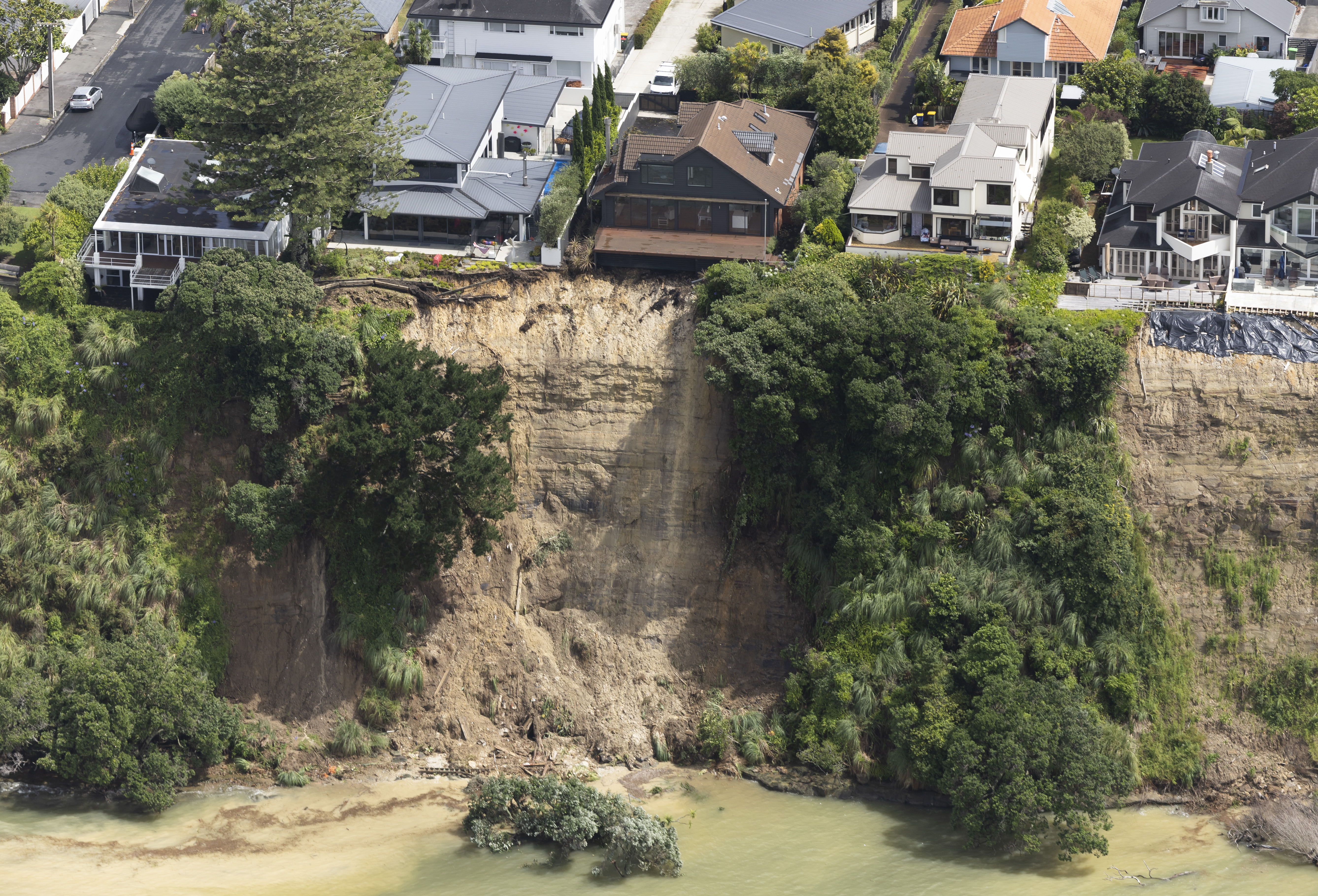 Coastal erosion threatened properties in Auckland after the 2023 floods. Photo / Brett Phibbs