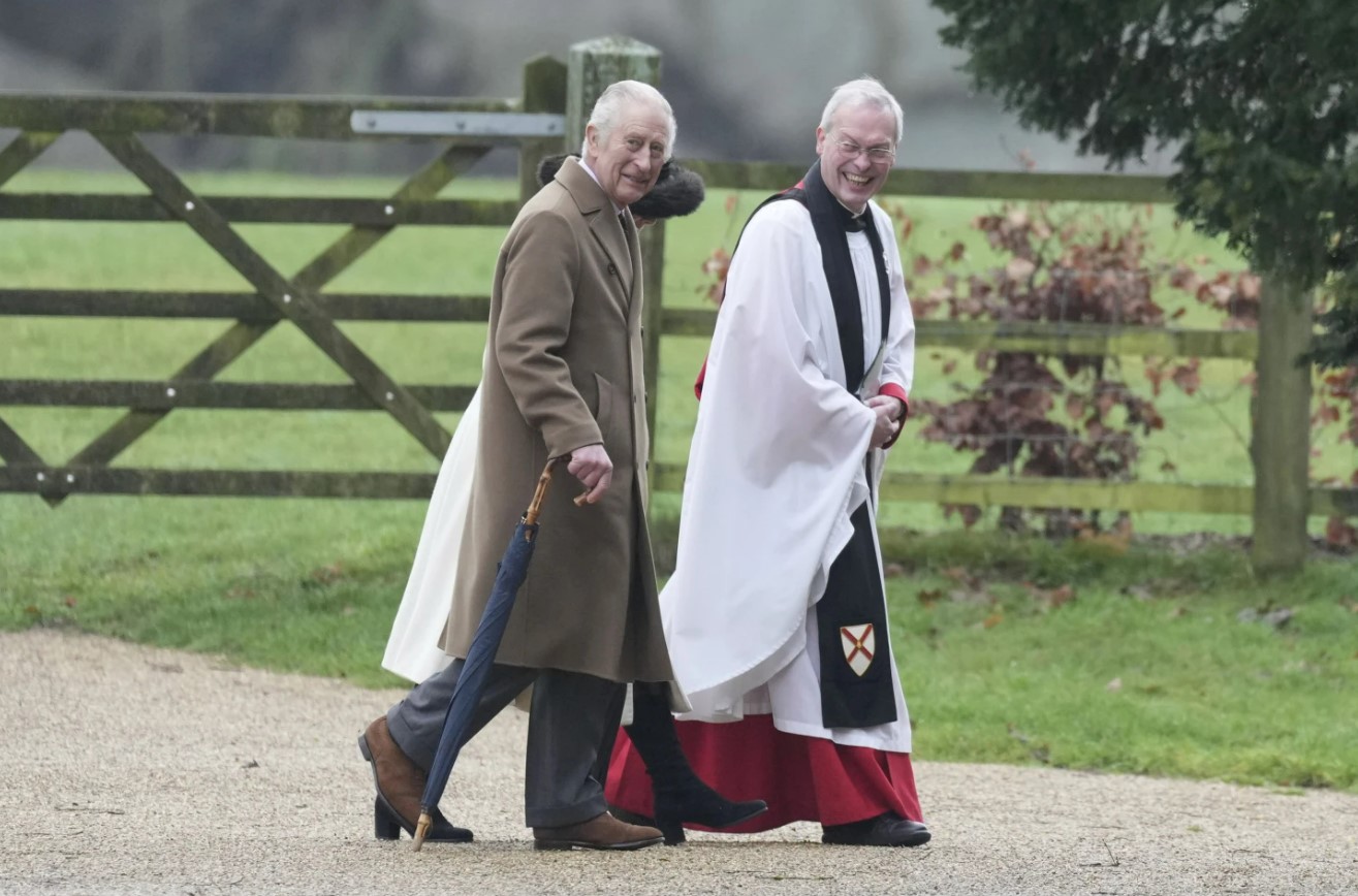 The King and Queen walk with Canon Paul Williams as they arrive to attend a Sunday church service at St Mary Magdalene Church, in Sandringham, Norfolk, England, on Sunday. Photo / AP