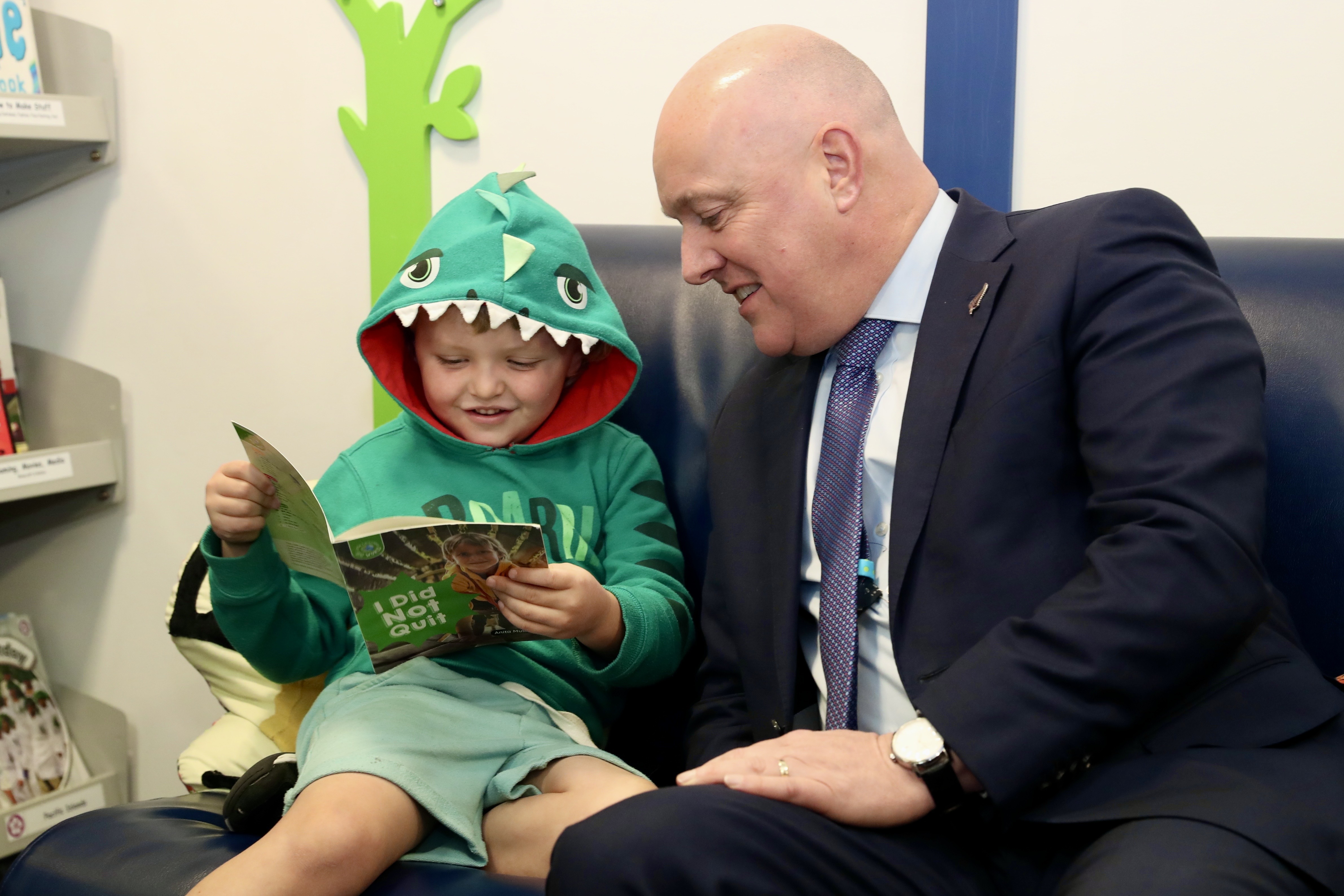 Prime Minister Christopher Luxon reads with a student at Silverstream primary school. Photo / Mark Mitchell