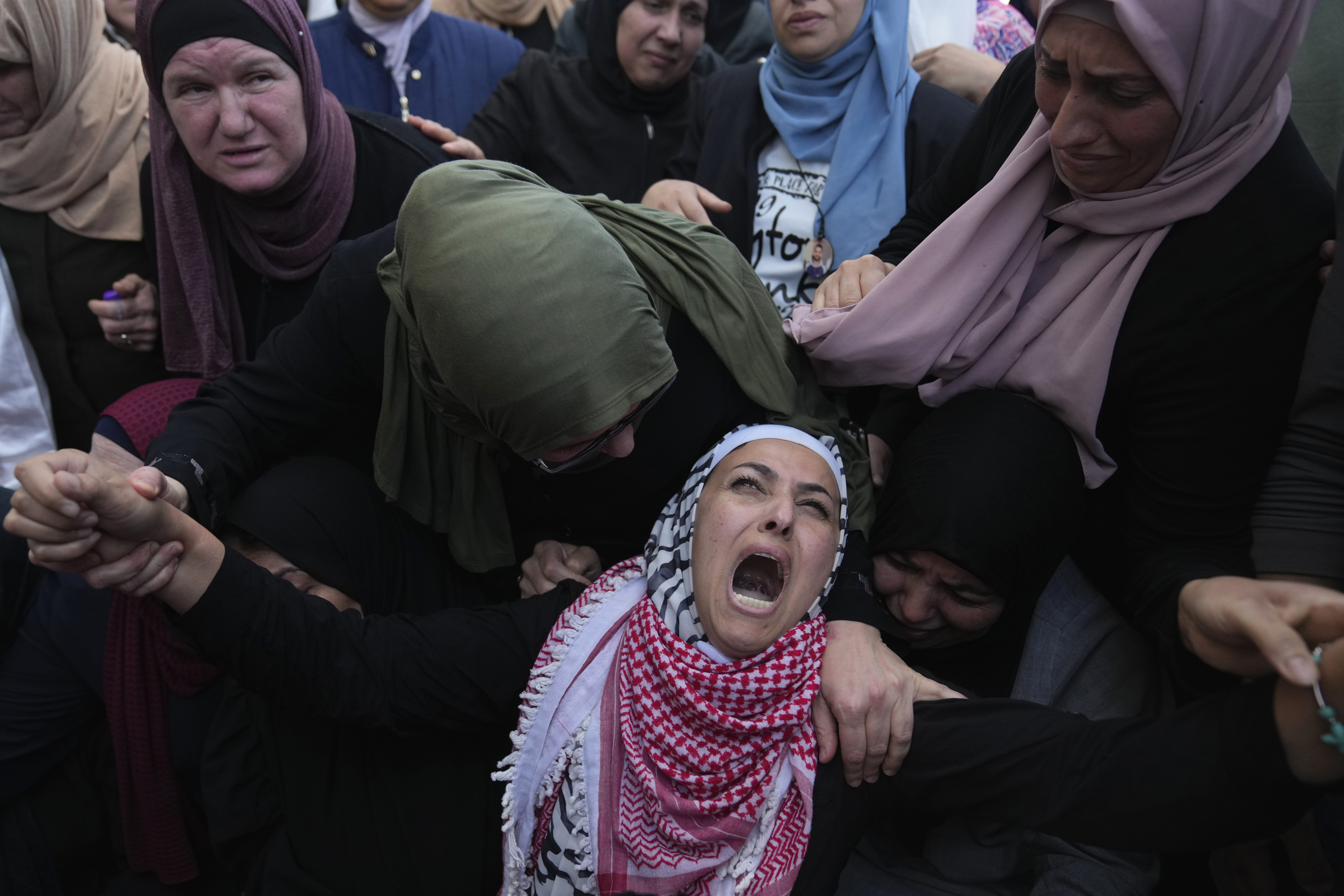 Palestinian Fayrouz Safi cries while she takes the last look at the body of her son Aysar Safi, 20, at the family house during his funeral in the West Bank refugee camp of Jalazoun. Photo / AP